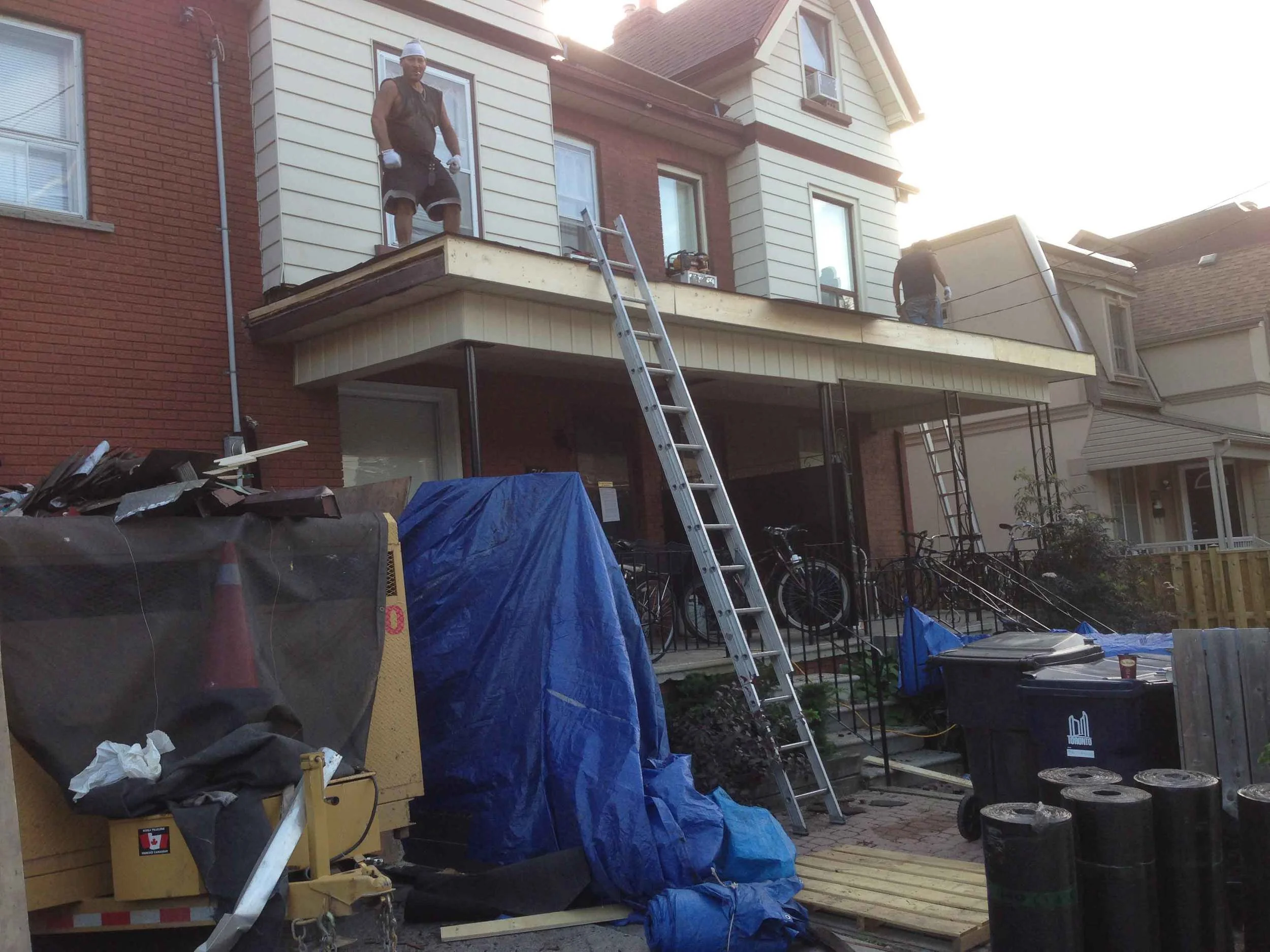 Rotten wood around front porch going in. Front shingles done and cleaned up.