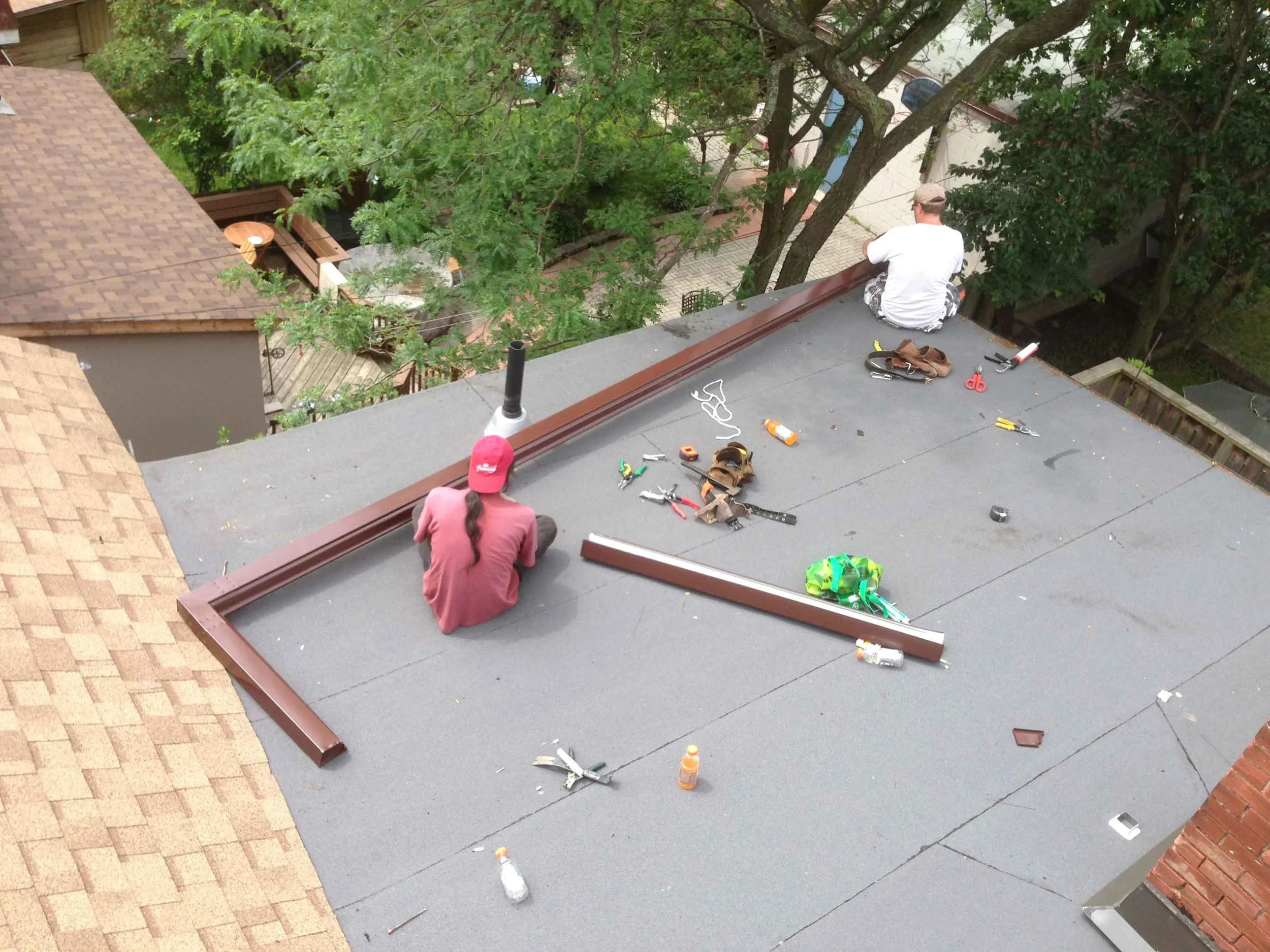 Rear flat roof is done and the rear shingled slope and the new eaves troughs are going in.