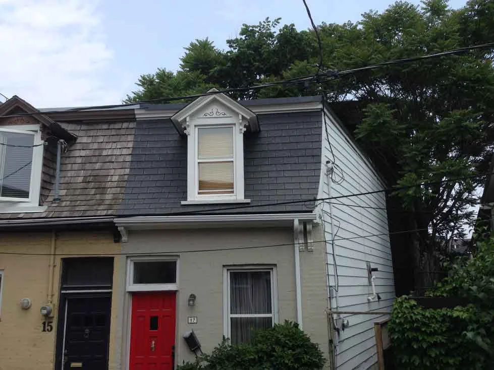 New shingles shown, all moulding in the roof area painted and the new eaves are in.