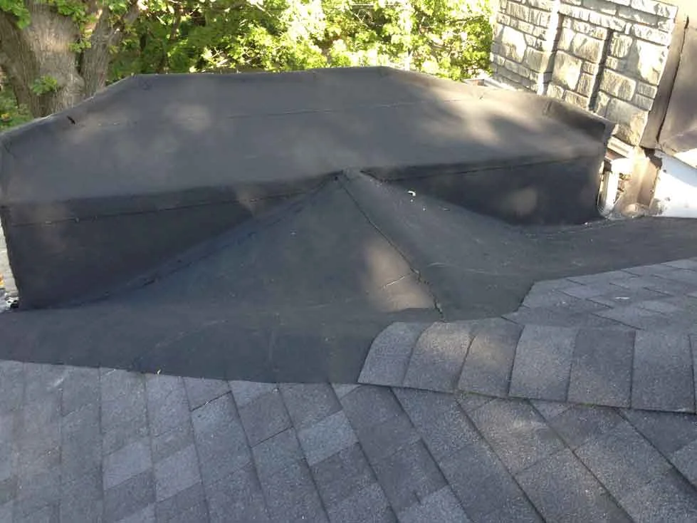 Another one is finished. Note that this is sloped back towards the house so that the water will drain back and be safe from icicles over the front door. Roof will go easily over 20 years now.