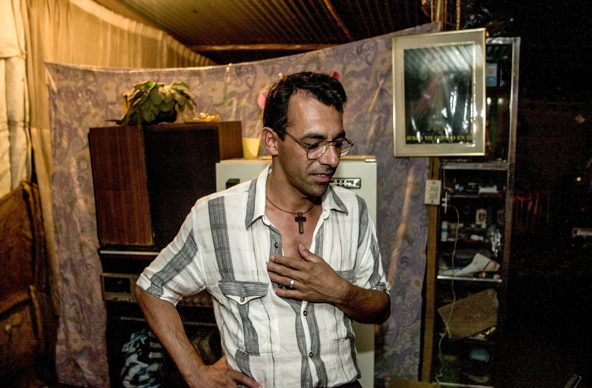 Hugo Molano, 35, in his home that is built from discarded canvas sacks. He was a policeman in Los Pozos and was forced to leave everything behind because the FARC guerrilla group threatened him. 