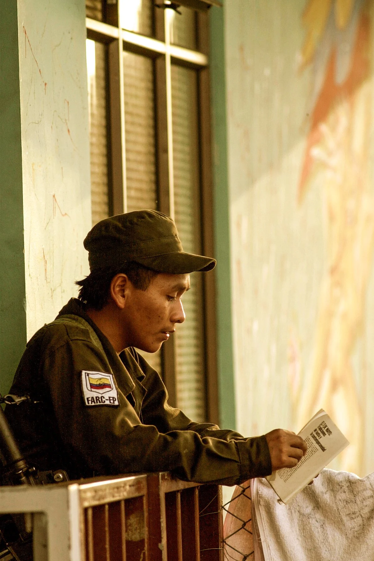 A FARC soldier reads a book about the history of communism in the Soviet Union at a FARC training camp outside of Los Pozos, Colombia. 
