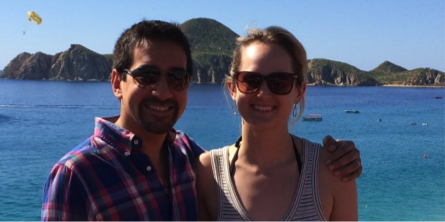 My husband and I, photographed in front of the beachfront view that could be ours...
