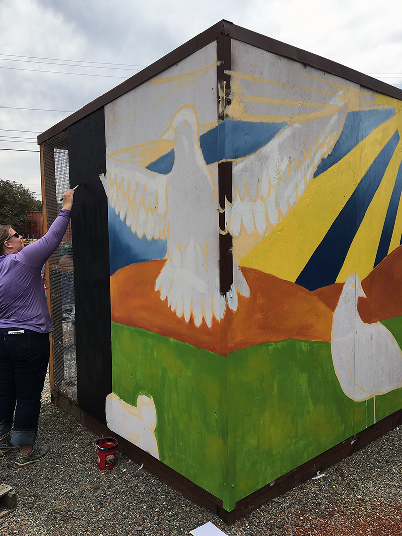 Ruthie painting in the black chalkboard section. They'll be able to use this for quotes and news/info... how fun!