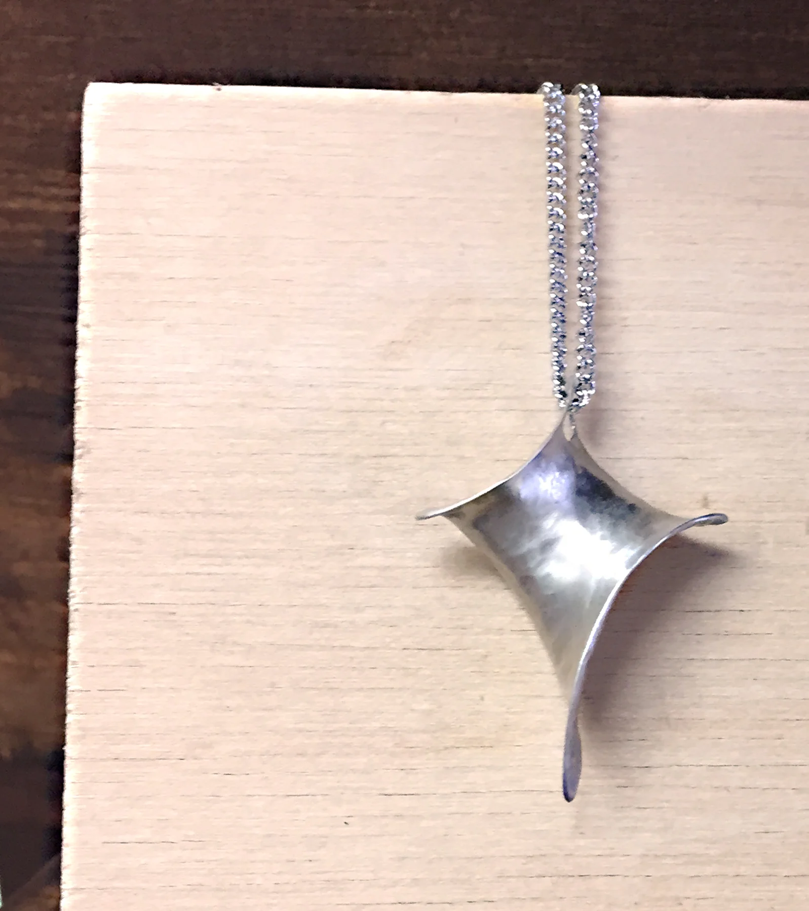 Anticlastic cross pendant