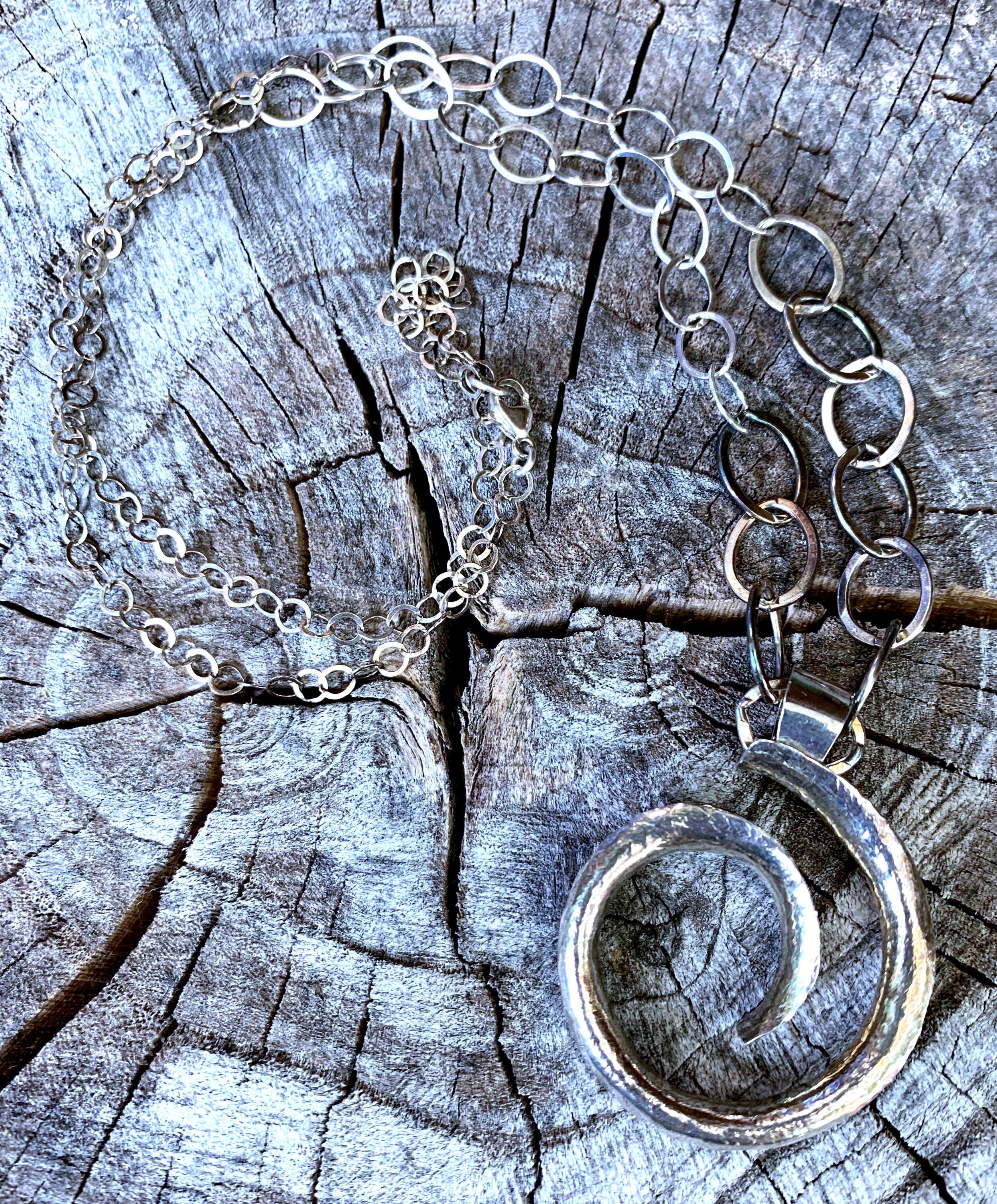 Sterling silver anticlastic spiral pendant on graduated cable chain