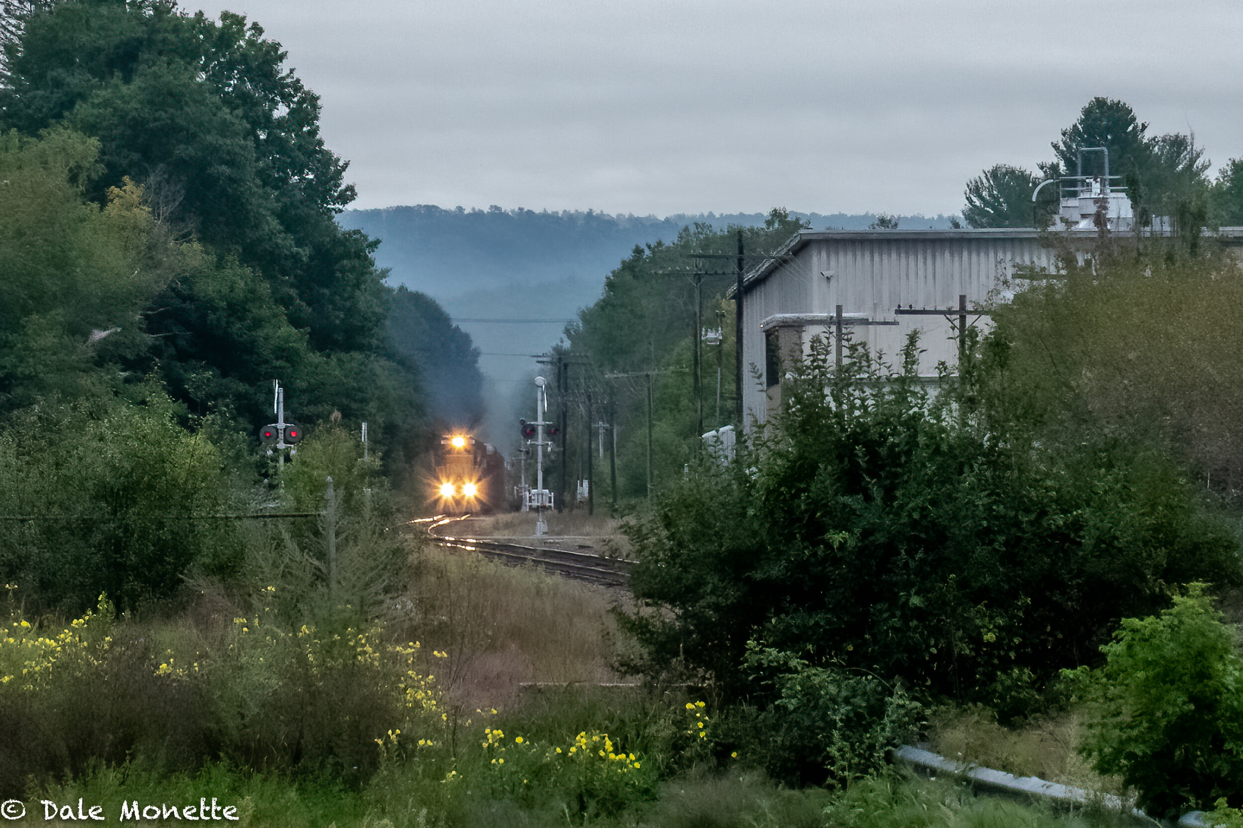   Another freight train heading west through Orange MA.  Pan Am railways is for sale.   These huge diesels will all be painted a different color when a new buyer owns this company.  These colors will be extinct so I try to get photos of them every ch