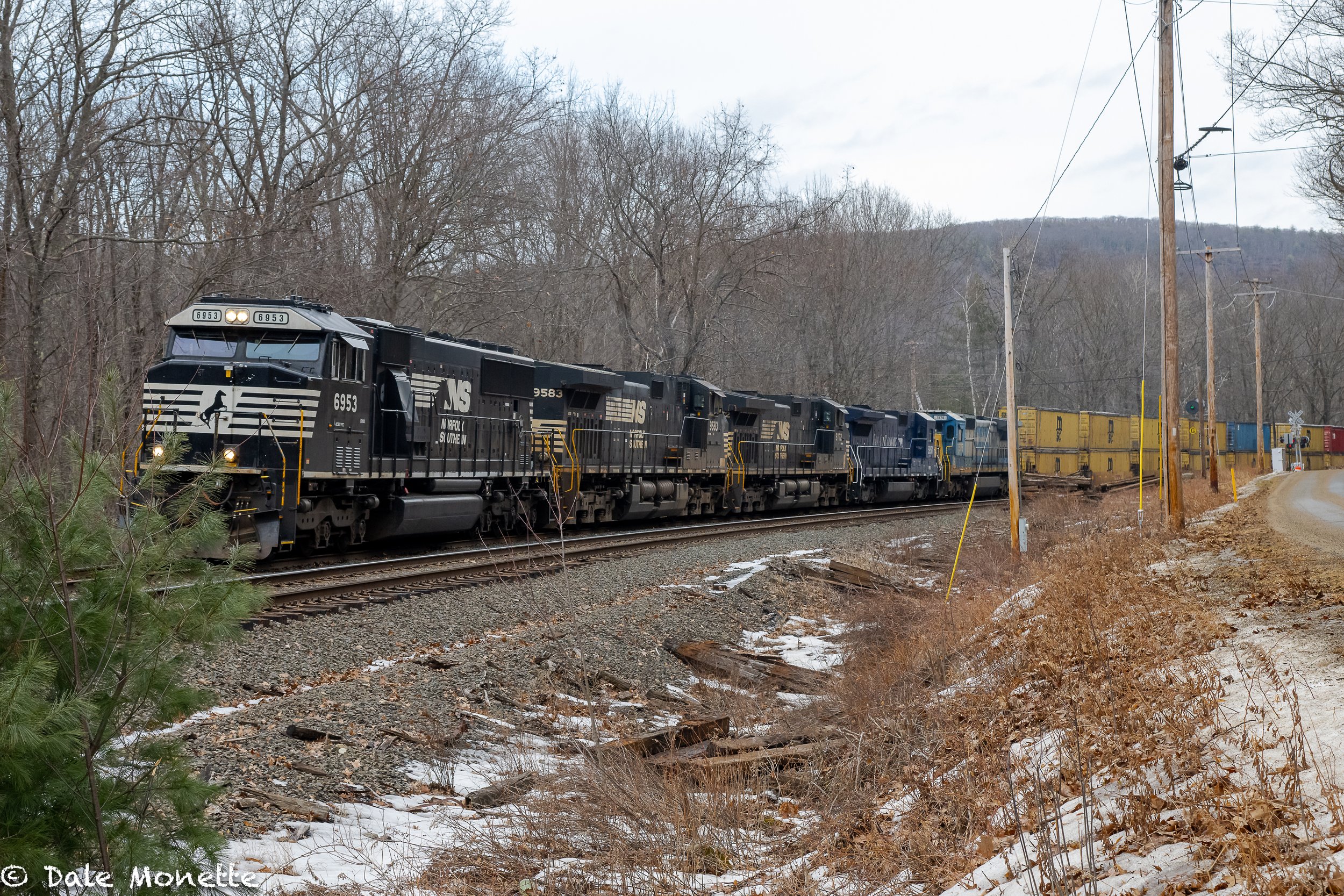   The Pan Am, Portland to East Deerfield freight train is rolling thru Farley, MA on a grey February afternoon. Note the 5 diesels tugging it along.  