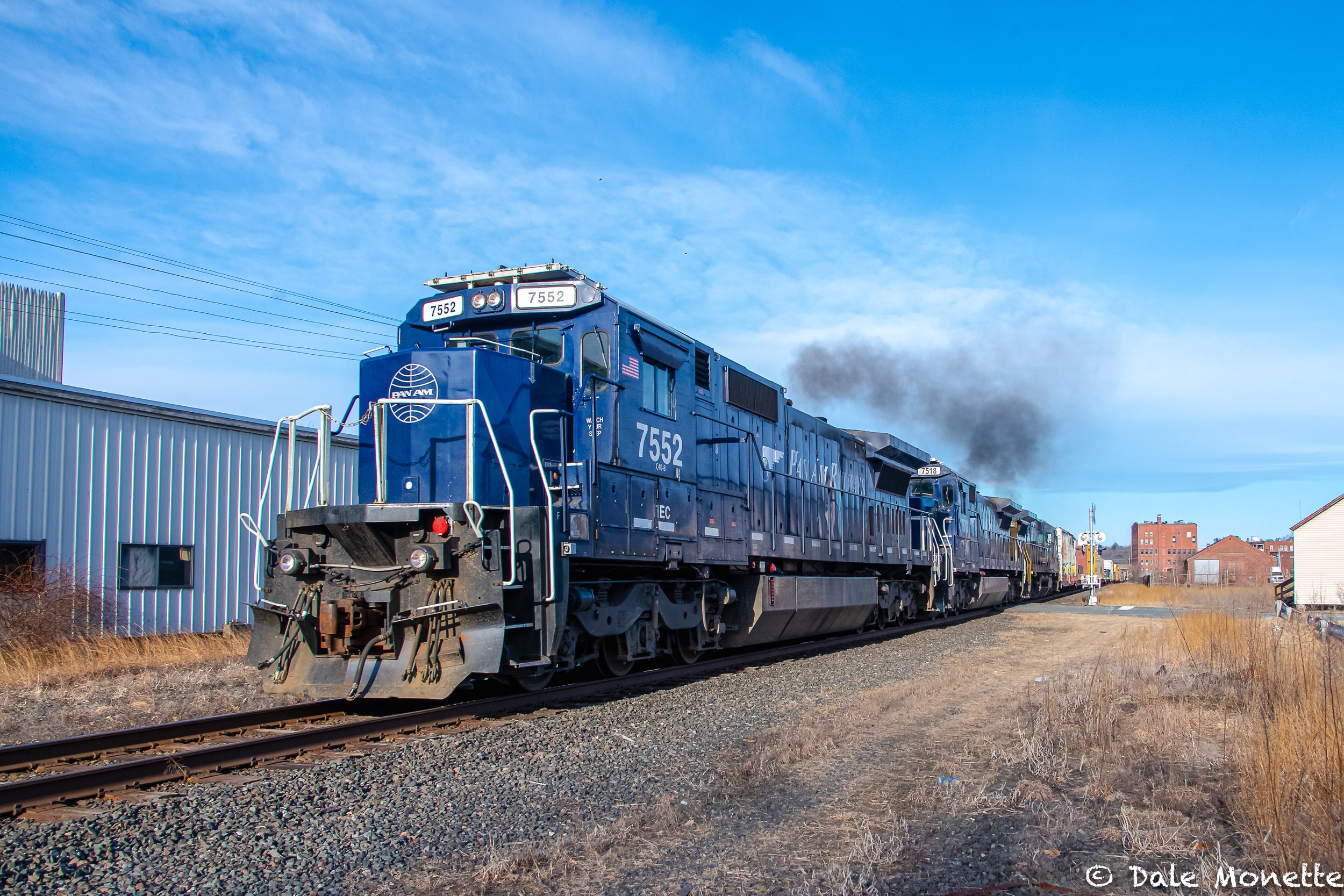   East Deerfield to Portland Pan Am freight train thru Orange MA belching out smoke from its 5 diesels on a 20 F degree late March Tuesday.  