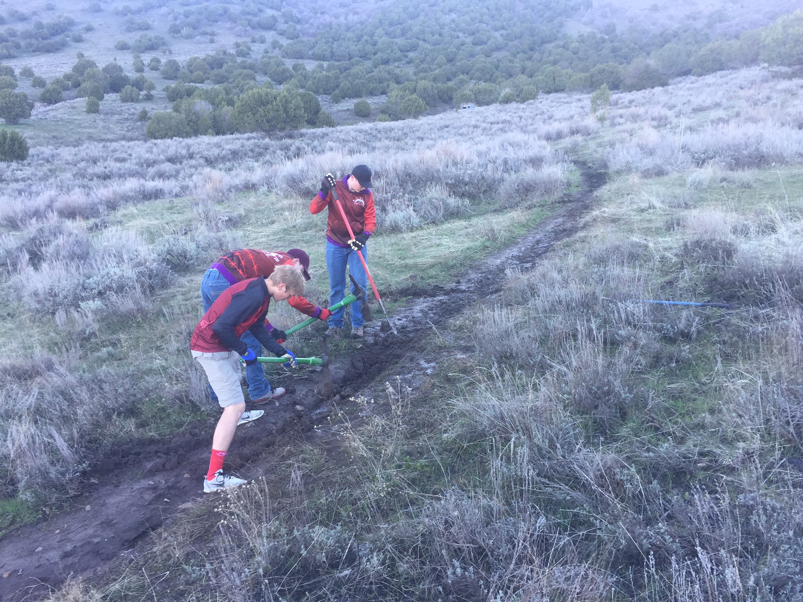Pictured above: Box Elder Composite Team providing care to fix ruts on a muddy trail - 2017