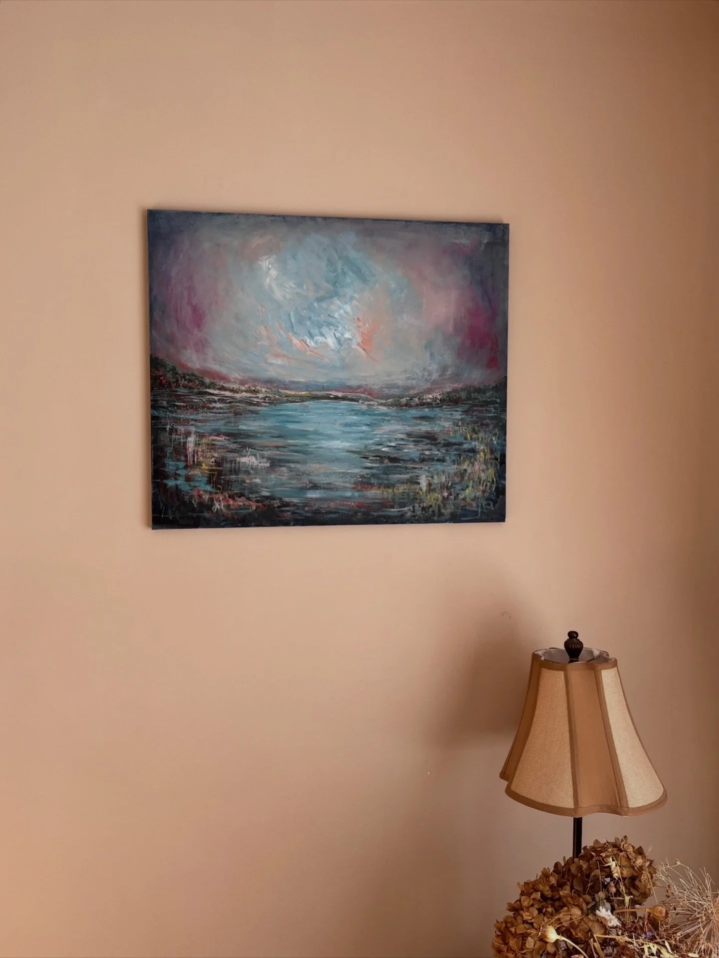 One painting, 2 different spaces and light sources. Where you choose to display your artwork makes such a difference to the colours and mood of the painting. 
A bright naturally lit room can add a lighter cooler feel to the art, whereas a darker wall