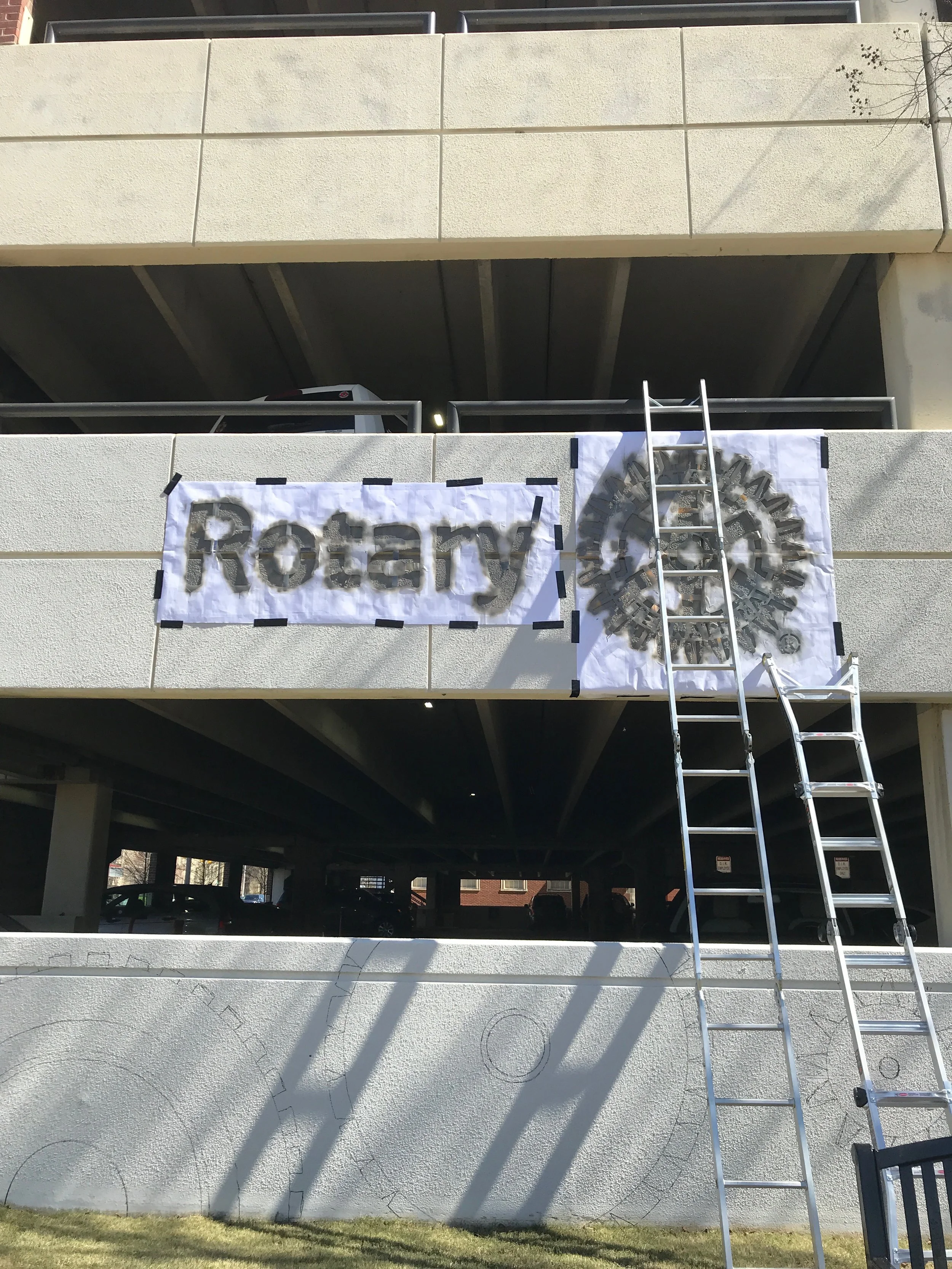 Day Four: Rotary Club logo stencil spray painted