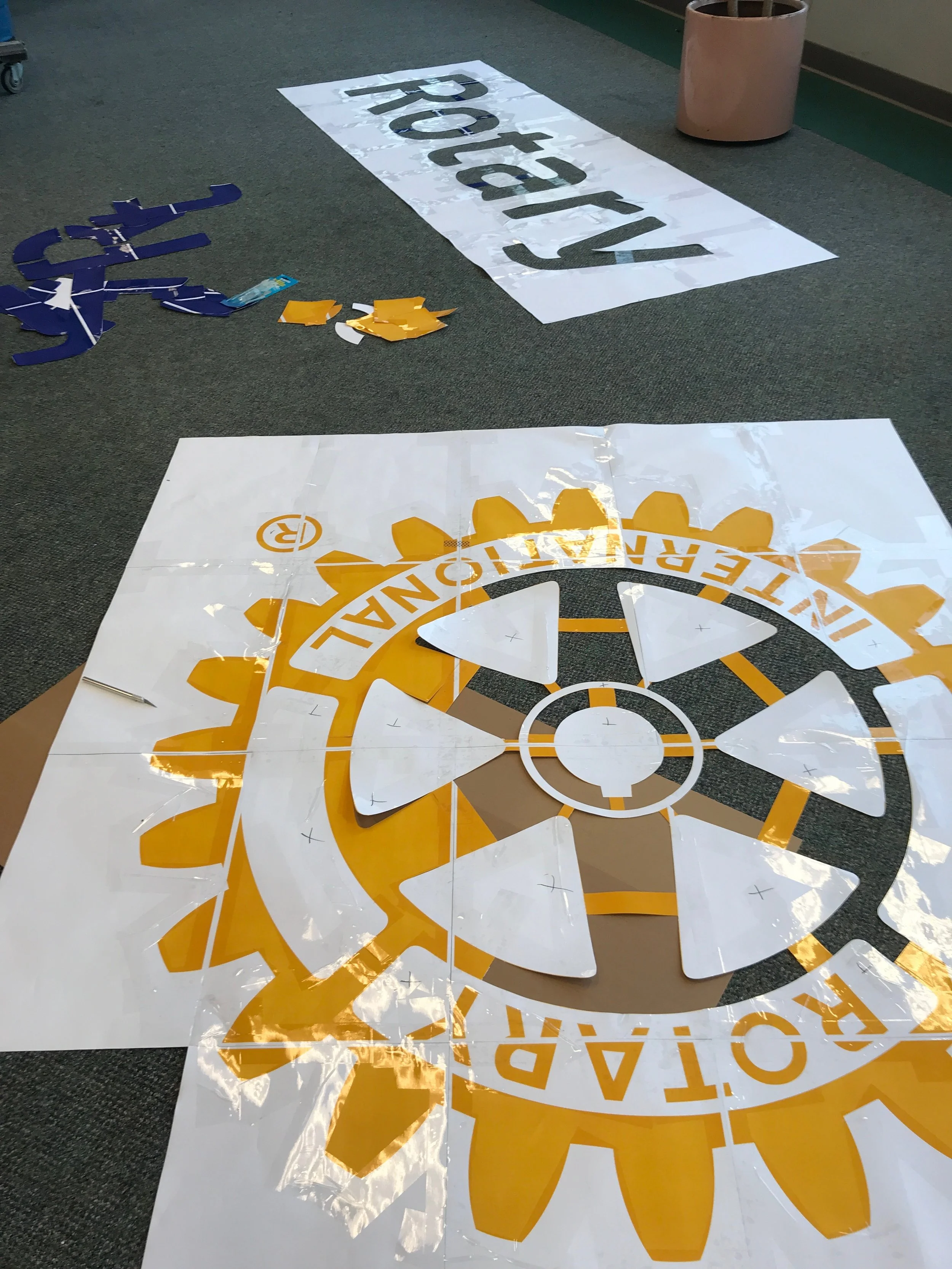 Rotary Club logo stencil, 12' x 5' total. Ten hours of labor to X-acto knife and tape.
