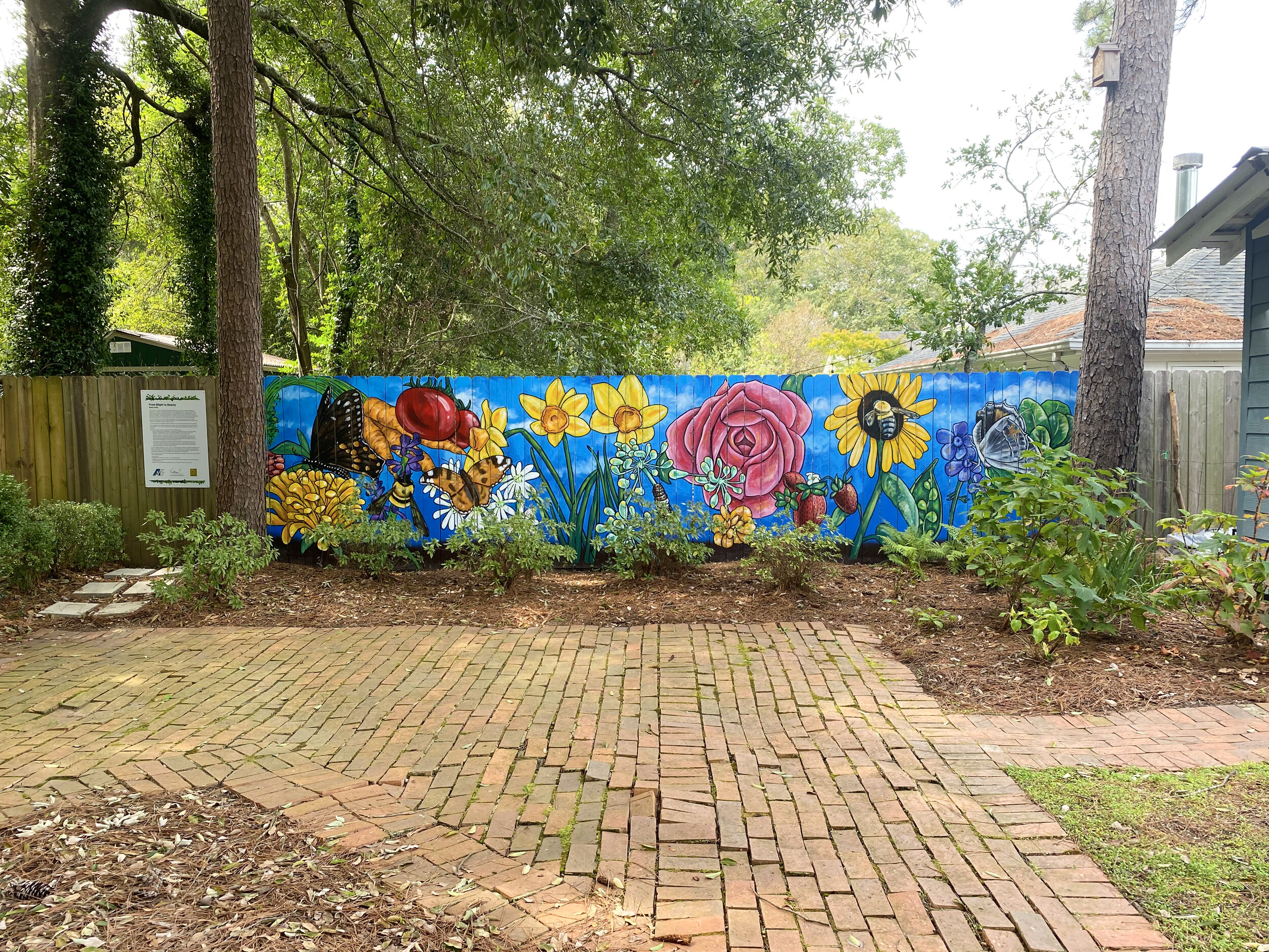   From Blight to Beauty.  Old Cloverdale Community Garden mural, Montgomery, AL. 25’x6’ exterior latex on wood. October 2020. 