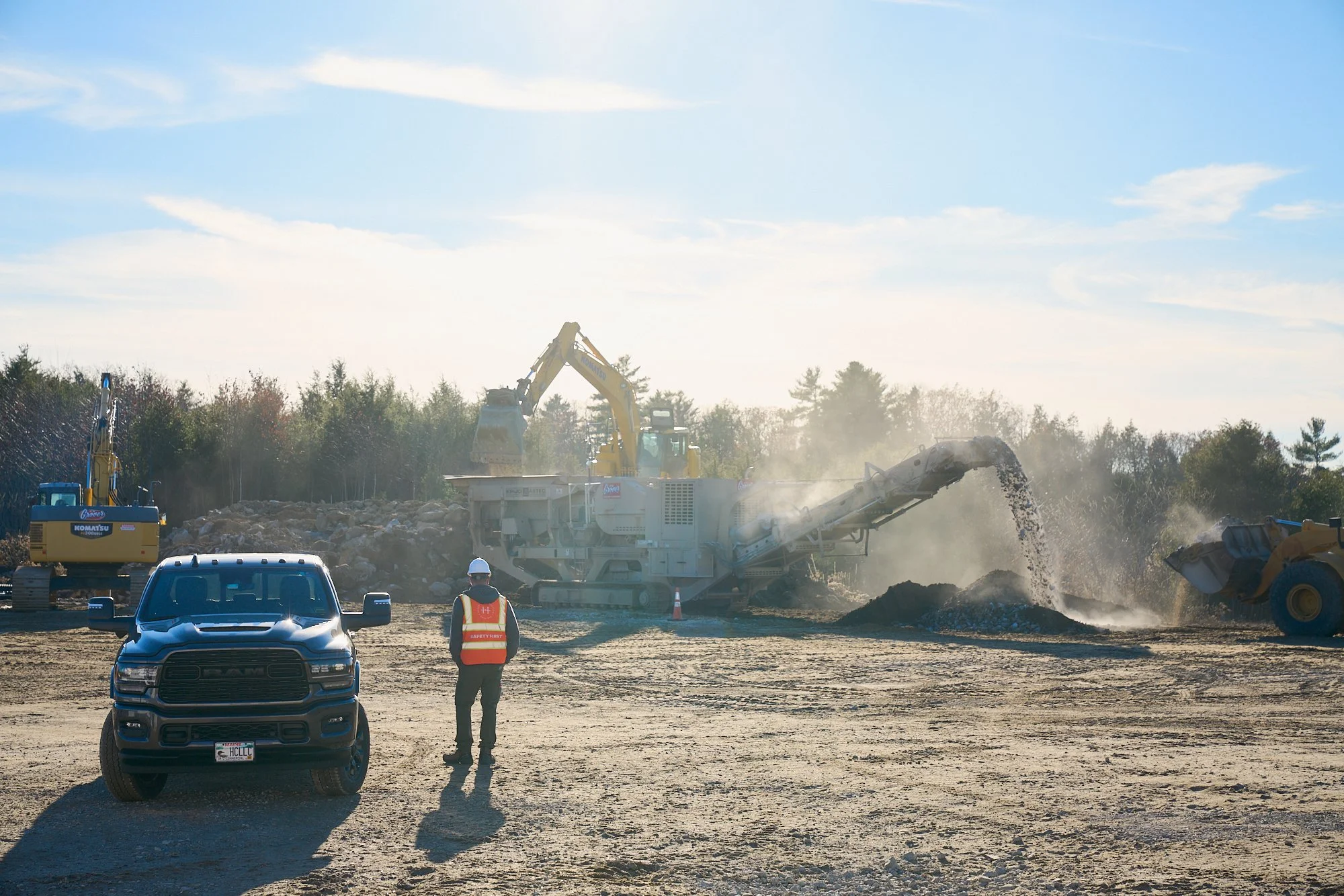 Jobsite super with dozer and rock crush in action, construction, photography
