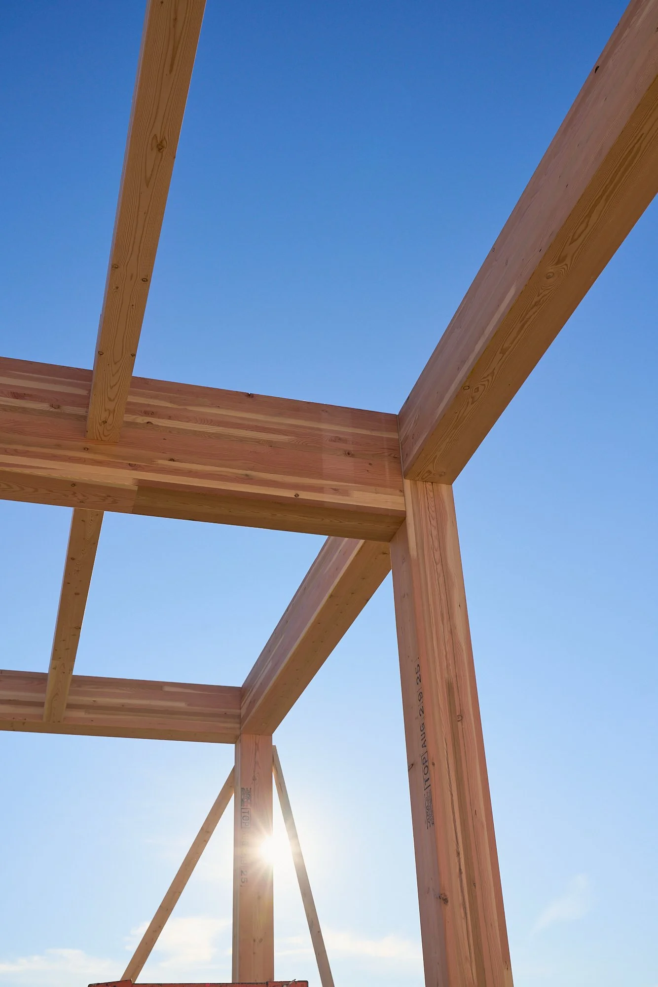 Wooden beams with blue sky and sun, construction, architecture, photography