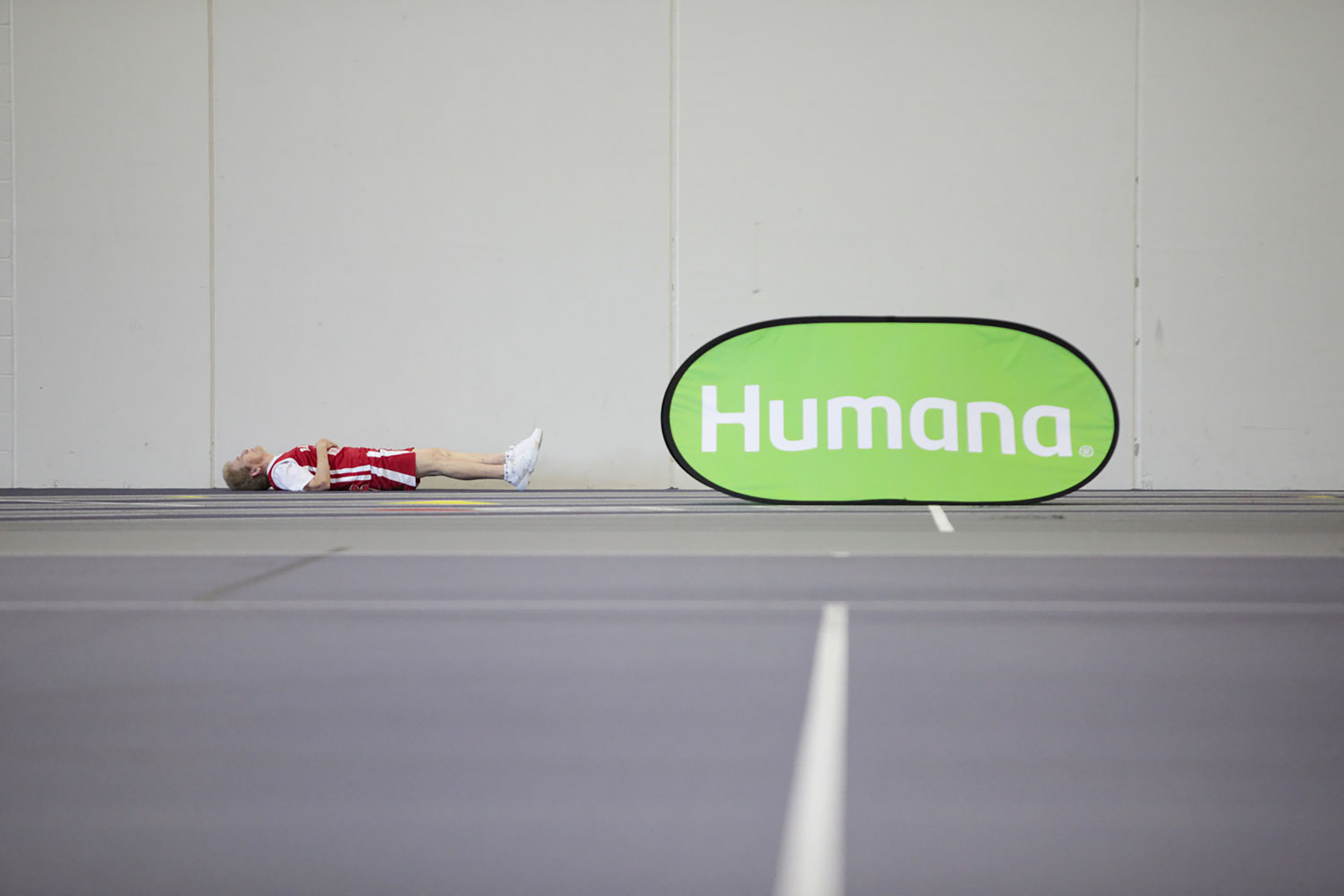  An athlete stretches next to a Humana sign during the 2015 National Senior Games basketball competition that took place on Jul. 14, 2015 at the University of St. Thomas Basketball Court in St. Paul, MN.&nbsp; 
