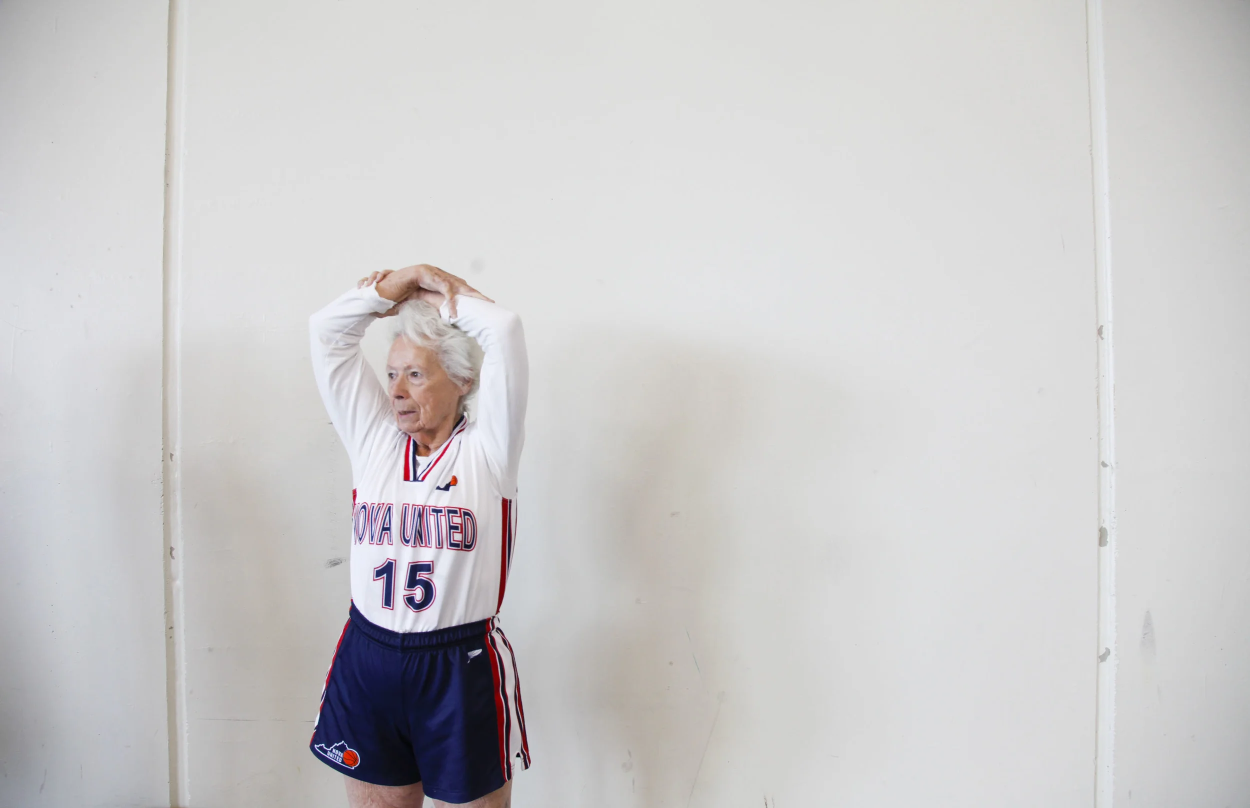 Judith Winston of the NOVA United Classics stretches before her game during the National Senior Games basketball competition. This competition took place at the St. Thomas University Basketball Court in St. Paul, MN. on Jul. 9, 2015. 