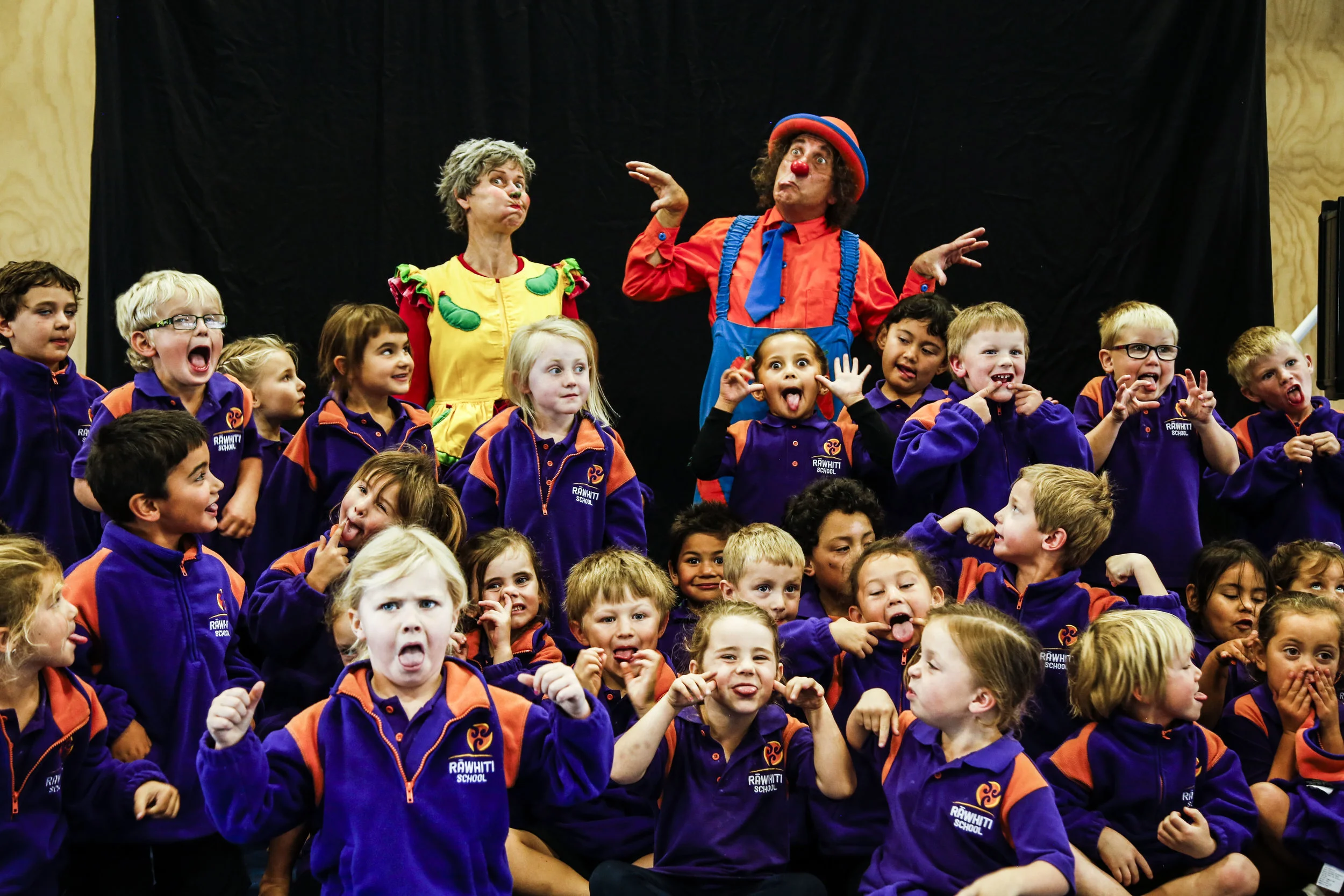 Wingfield (left) and Carrow (right) pose for pictures with the students after their performance on May 6, 2016 at Rawhiti School in Christchurch, NZ. "I love seeing the joy in children when we perform," says Wingfield.