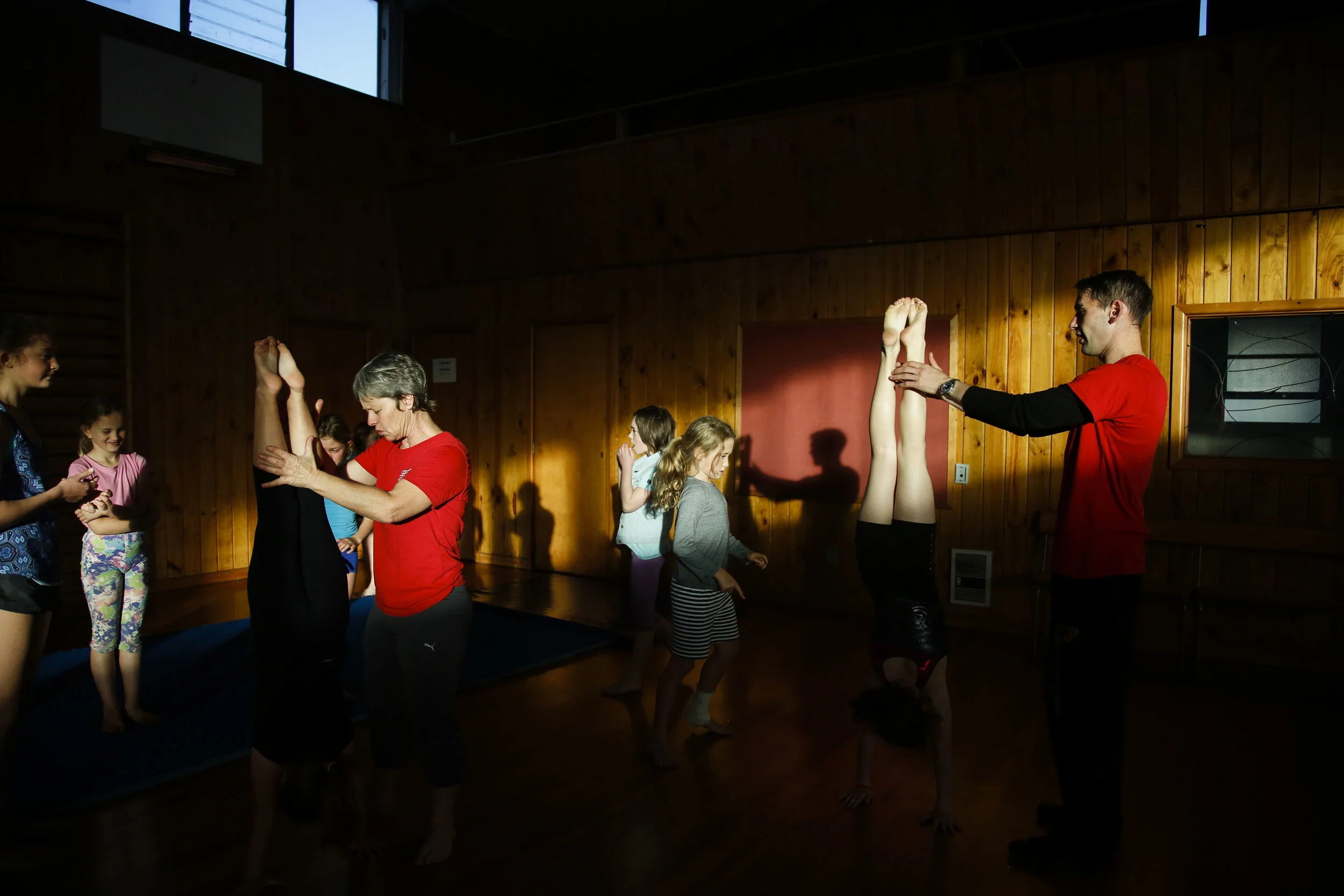 Wingfield (left) helps a student with her handstands during a class at the Christchurch Circus Centre in Christchurch, NZ on May 10, 2016. Wingfield and Carrow lost their original circus school to the 2011 Christchurch Earthquake. "We lost our circus school and started doing community circus workshops in town. But then that building had to get demolitioned as well. So we had to find a new venue. Luckily enough, Chris is really good at hunting for stuff."