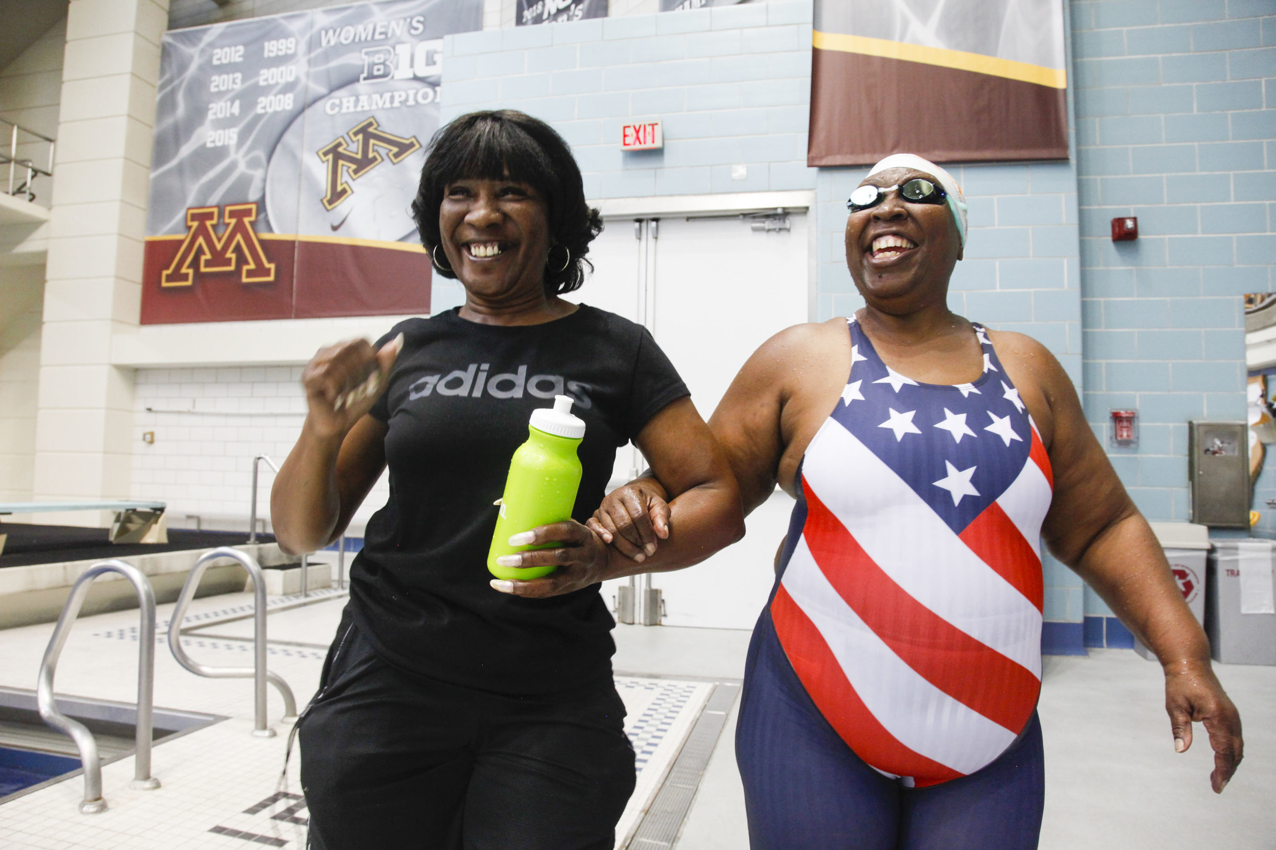  Patricia Henderson (left) dances as she guides her sister, &nbsp;Vivian Stancil (right) to the bleachers during the National Senior Games swim meet that took place at the University of Minneapolis Aquatic Center in Minneapolis, MN. on Jul. 8, 2015. 