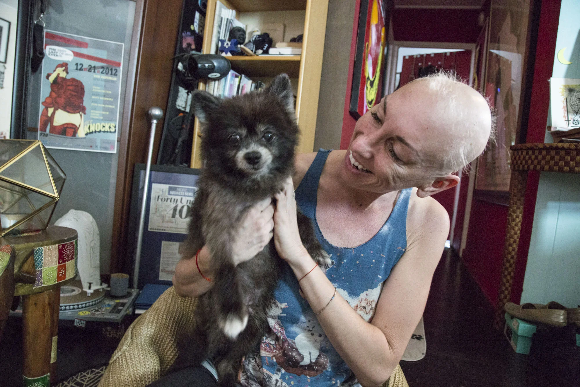  Wittmier holds up Boo Boo, her beloved  10-year-old black Pomeranian, in her Honolulu, HI home. BuBear was rescued in 2016 after Wittmierʻs long search for a service dog.  