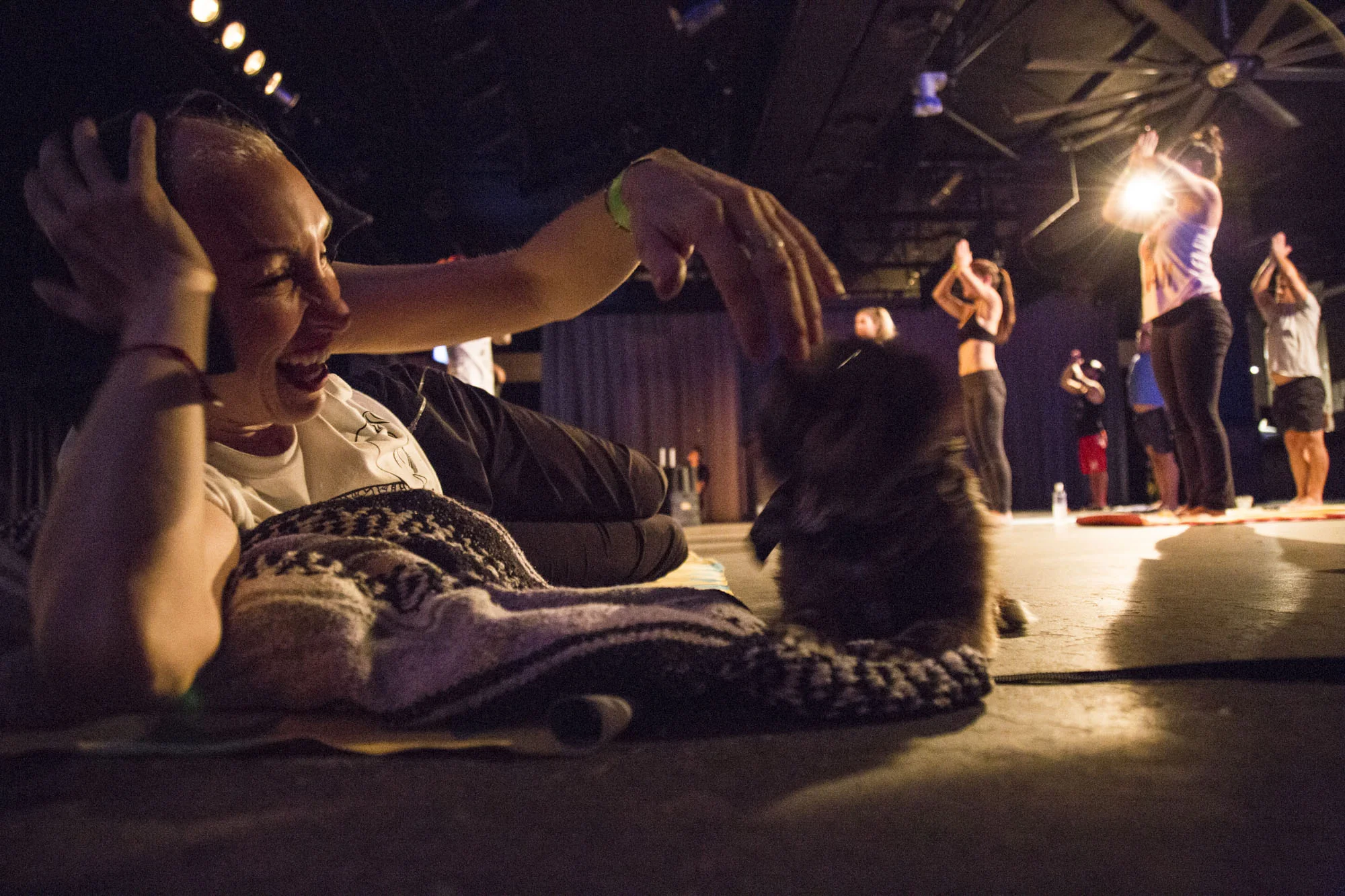  Christa laughs while playing with Boo Boo during the Republikʻs first-ever yoga event, ʻYoga Loves CWʻ, an event that was put together in support of her. 