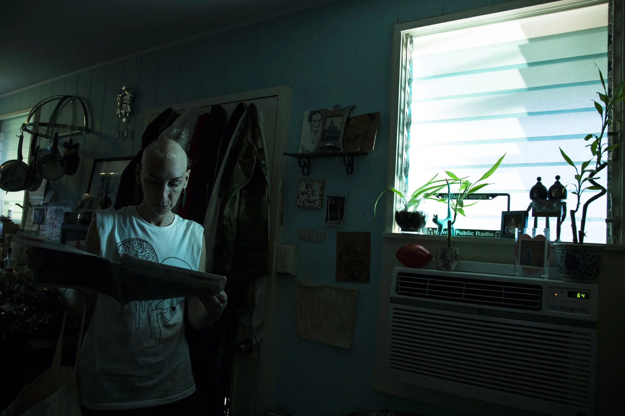  Wittmier looks at an old article written about her in her Honolulu, HI home.  