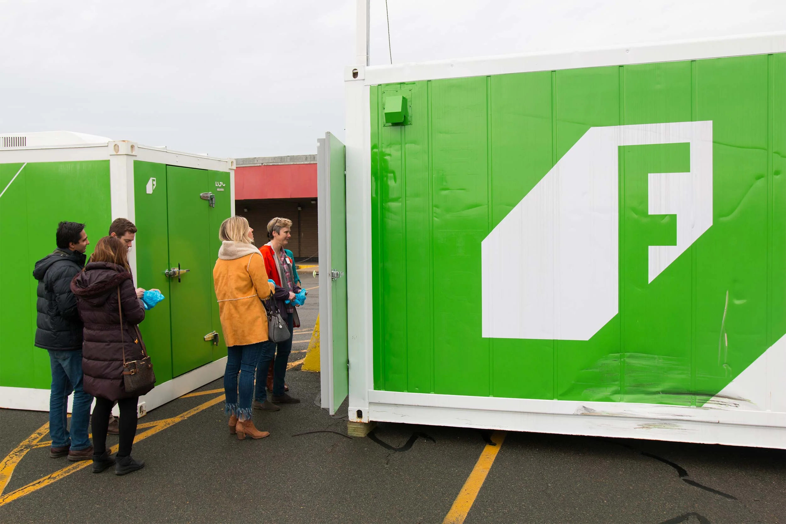 Open house guests wait excitedly to enter the container farm (the Leafy Green Machine™). Each 320 sq. ft. farm can comfortably fit 10 people at a time.
