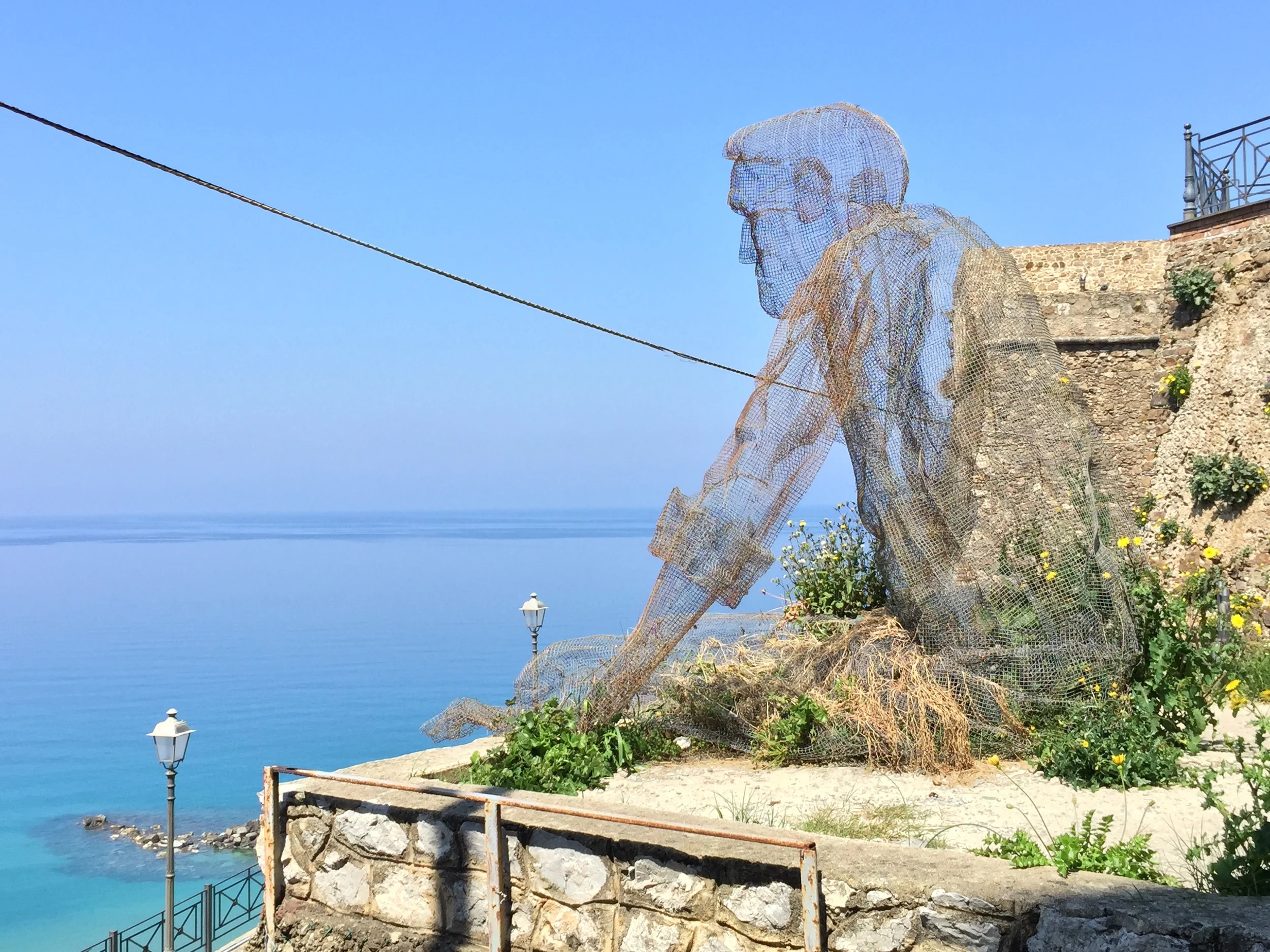 The old man and the sea, iron net statue by Eduardo Tresoldi, Pizzo.