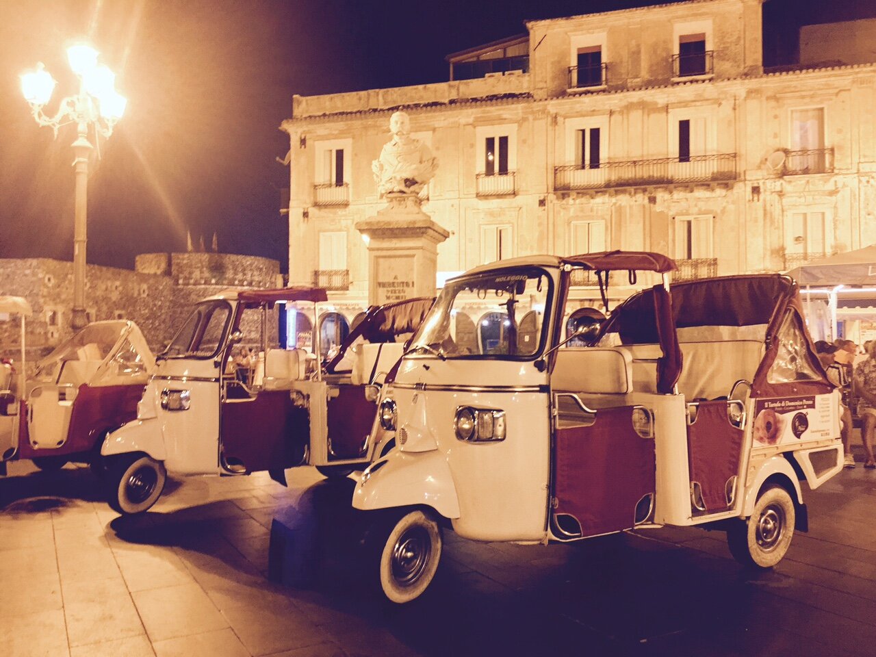 Ape taxi waiting in piazza