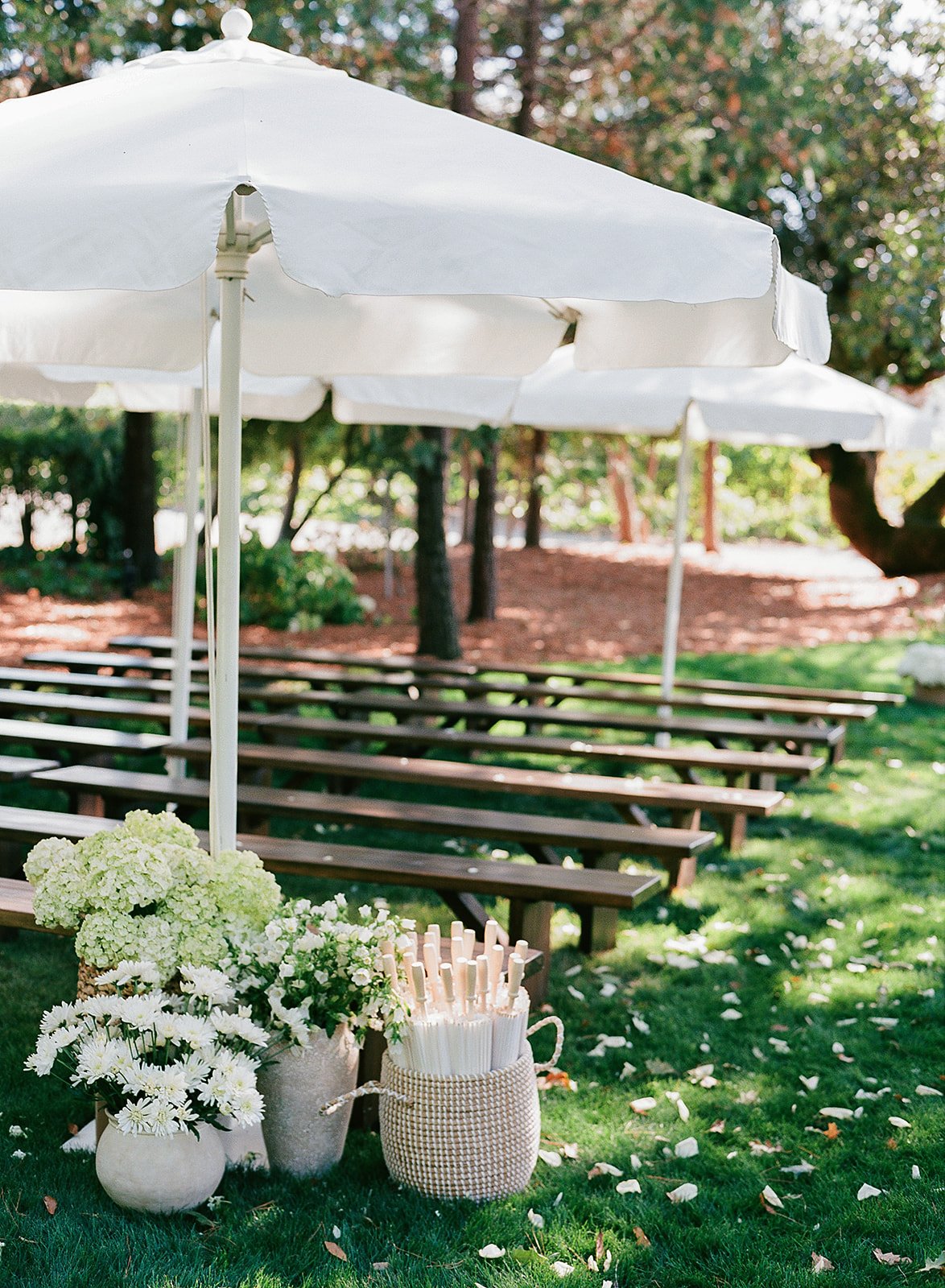 Outdoor wedding ceremony beneath oak trees at Oak Grove Estate in Sonoma County, with curated aisle decor by L’Relyea Events