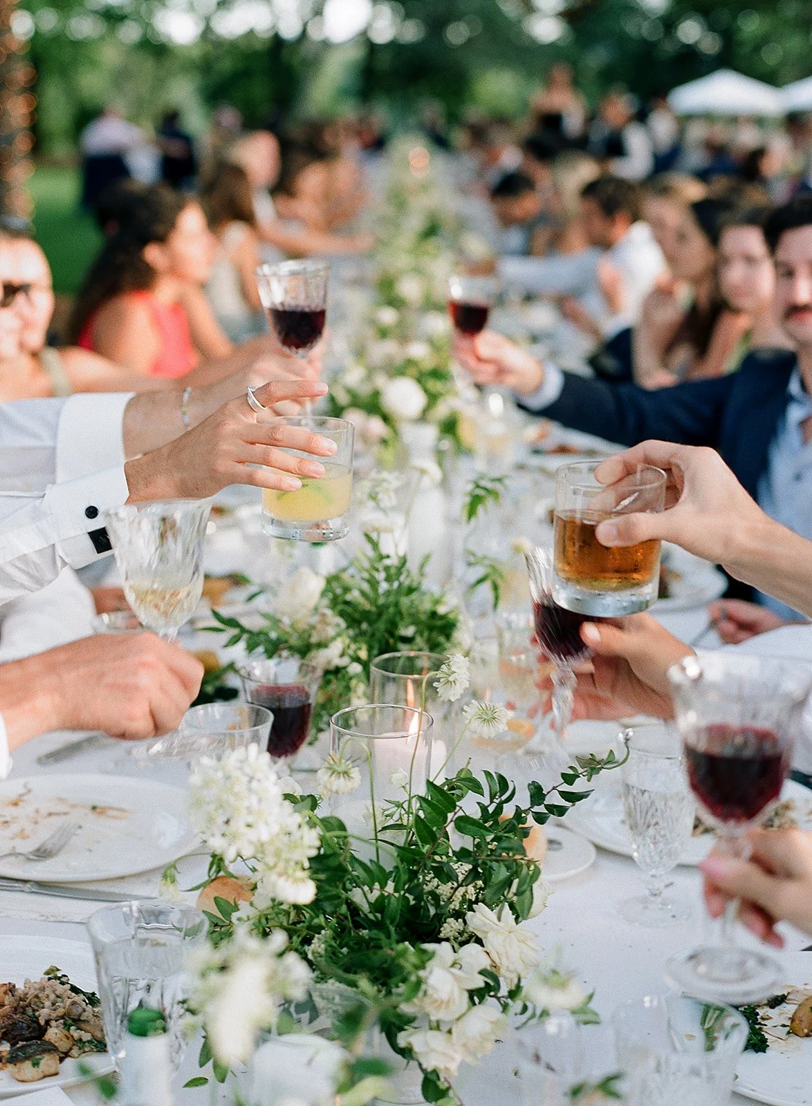 Guest candid moments at vineyard reception tables under oak trees at Sonoma County Oak Grove Estate wedding by L’Relyea Events