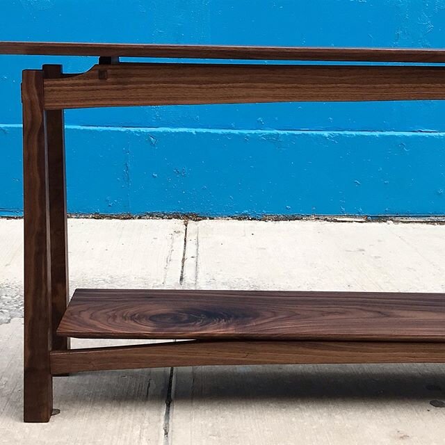 Walnut sofa table. One of our favorites. Some nice curves and exposed joinery with a floating top.