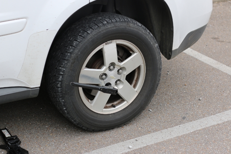  Use a tire iron to loosen the lug nuts before you lift the car. Photos by Braxton Maclean.&nbsp; 