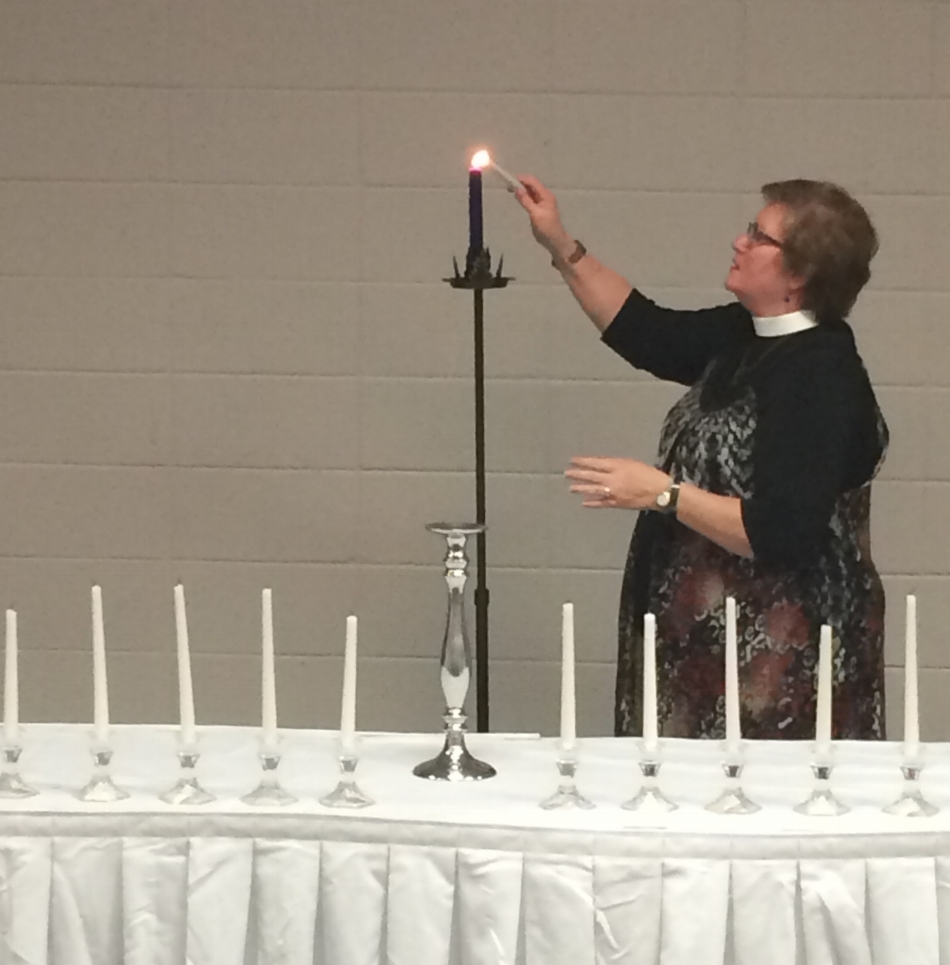The candle representing senior spirit is lit at 100th Night. Photo by Lauren Trimm.