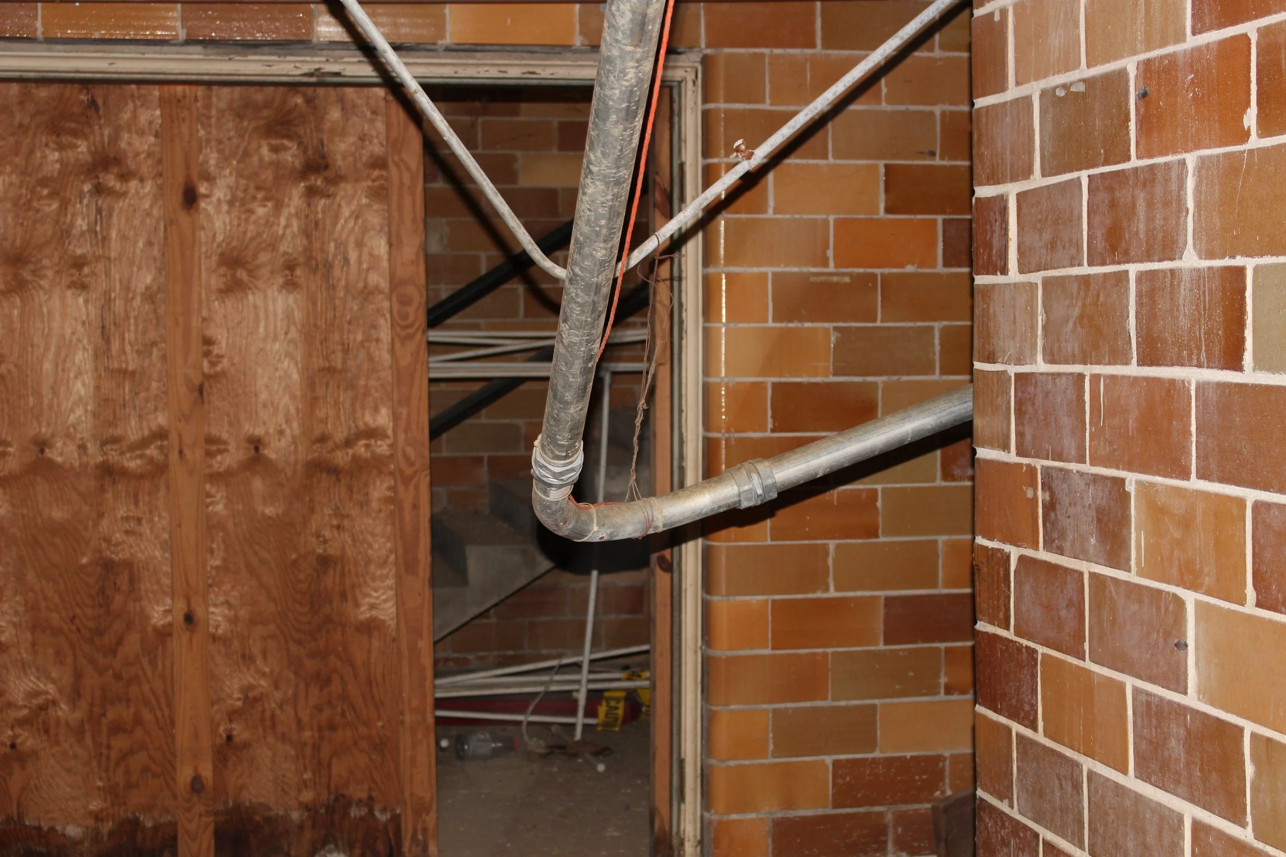  The hallway from the changing stalls and showers to the stairwell up to the pool.. 