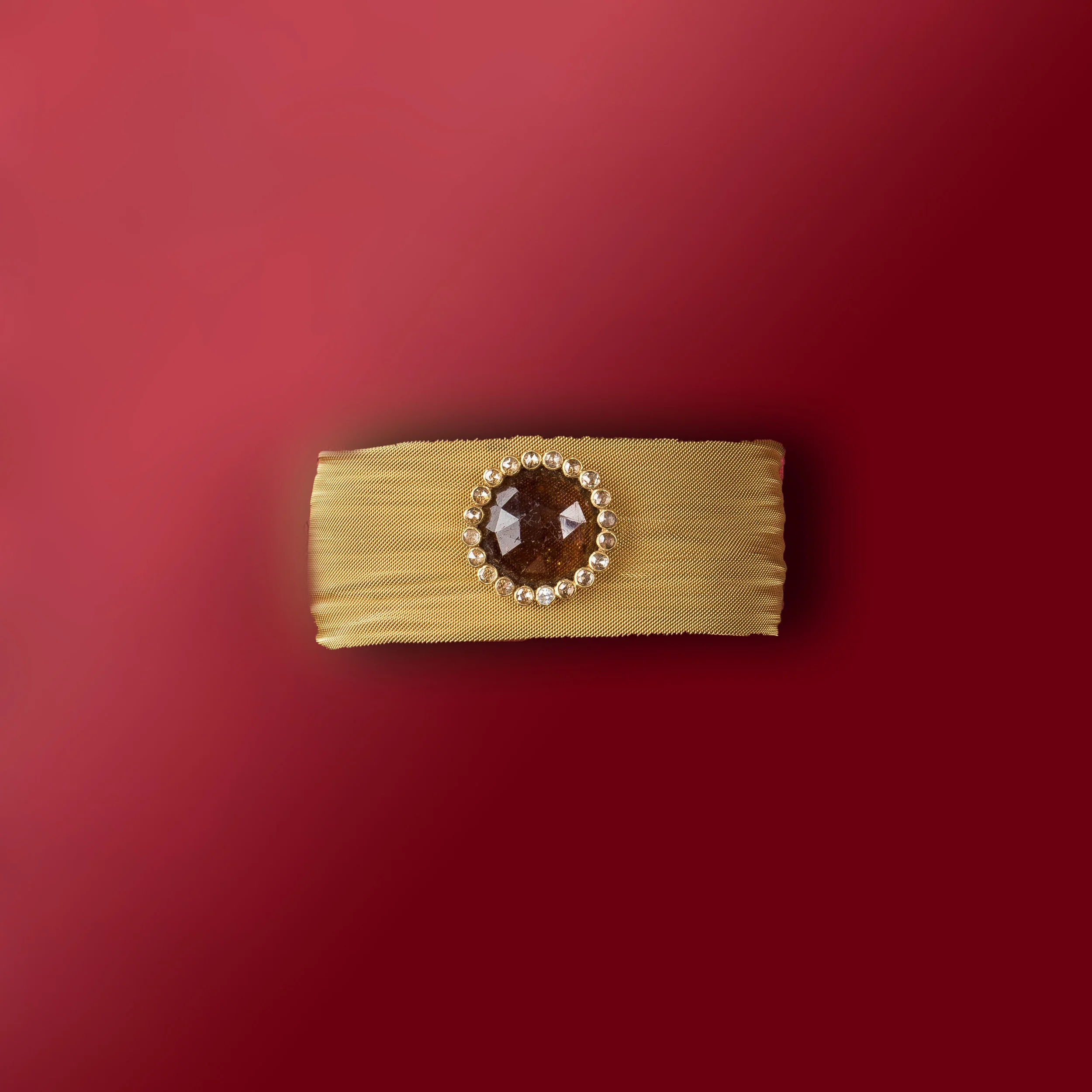 gold metal mesh snap bracelet, centered with topaz set in 14 ct gold and trimedin diamonds/b121