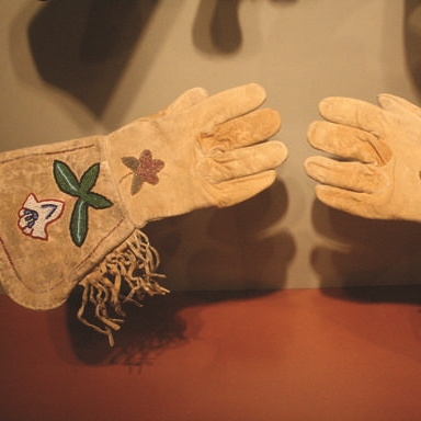 This particular pair of gauntlet gloves is Native American-made and was crafted from naturally tanned deer or elk leather, making them soft yet durable. 
