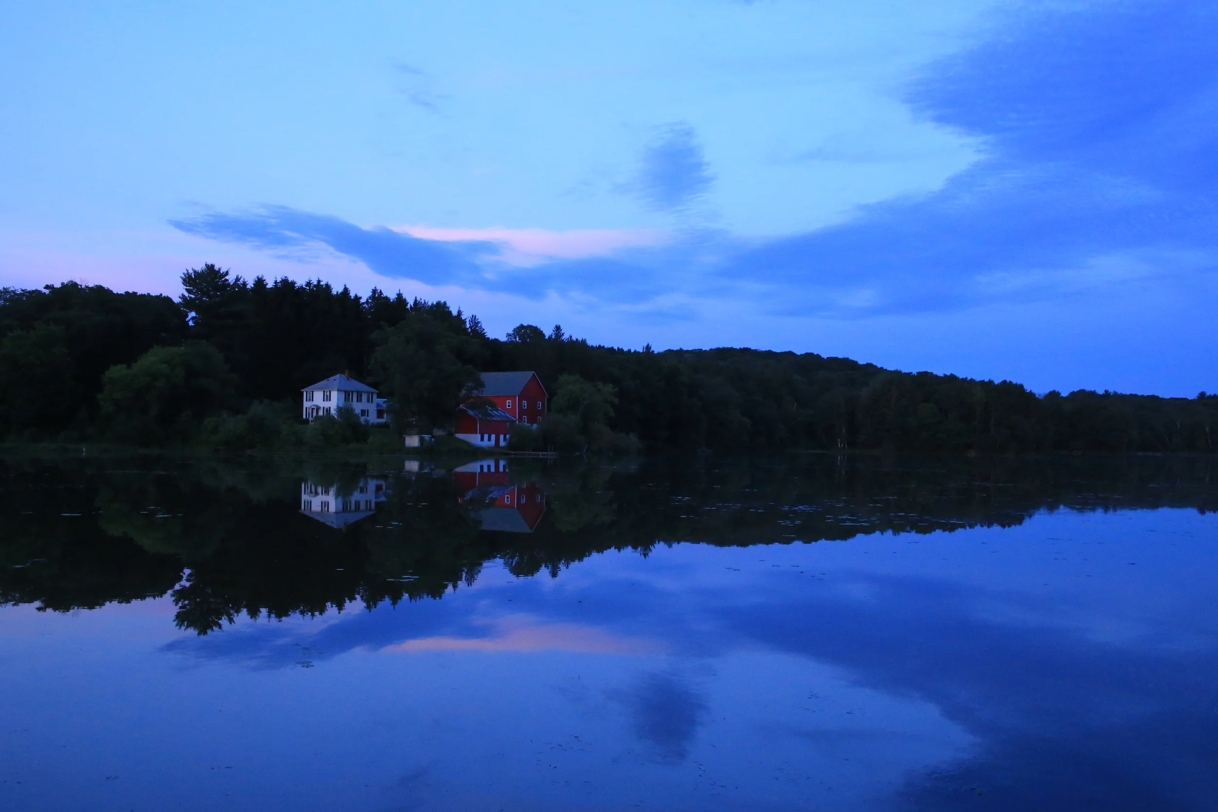 A beautiful summer evening wraps a purple light along the shore of Lily Springs. 