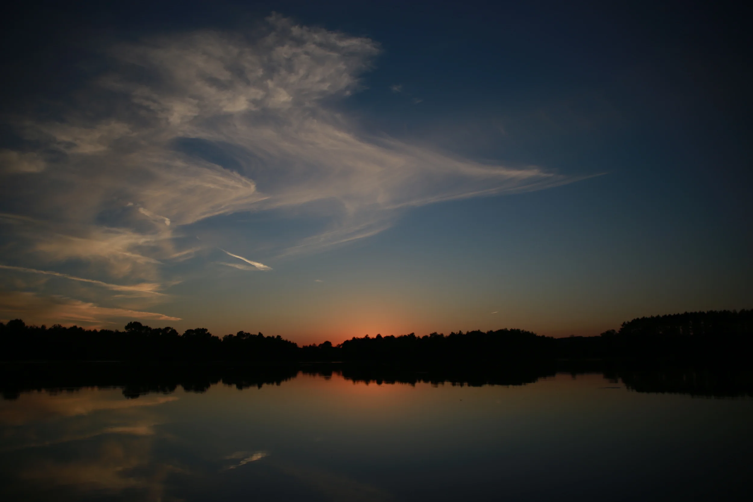 The sun sets over a placid evening on Mud Lake. Now, with winter's grip firmly holding the land and the lake in a state of hibernation, we take the time to reflect on our first year farming.