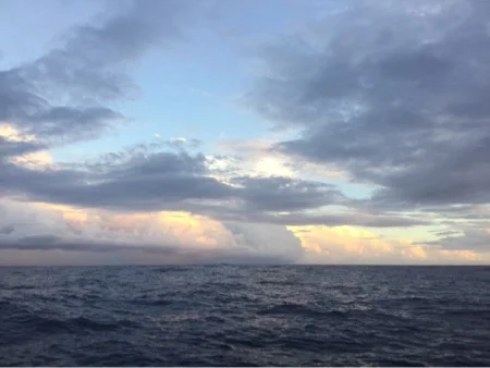 Rain clouds rolling in as the sun sets