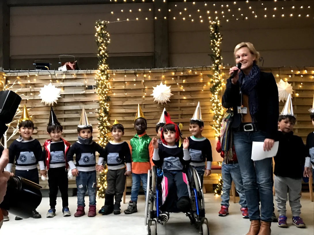 Children’s performance at Holiday - Christmas Market with Ms. Claudia Peppmueller who is in charge of PR. All photos are provided by Friedensdorf international