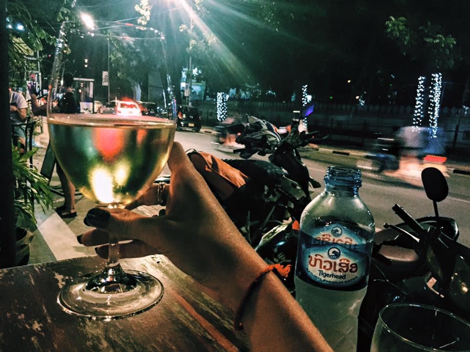I stepped off the plane from Vietnam an hour ago & now I'm enjoying a glass of wine at a little cafe in the capital of Laos. My evening = people-watching & enjoying the excitement/novelty of a new place.
