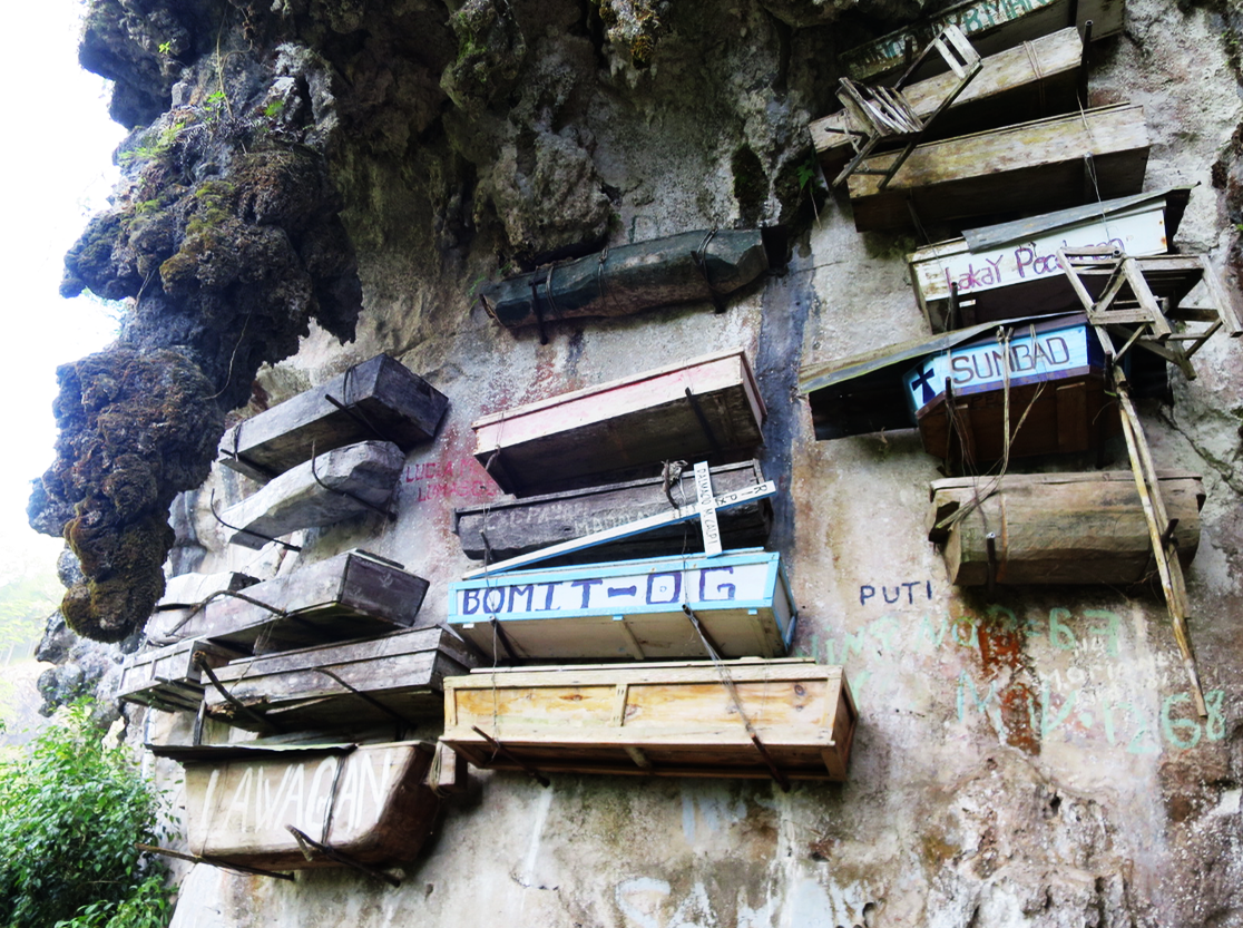 Hanging coffins along the cliff.