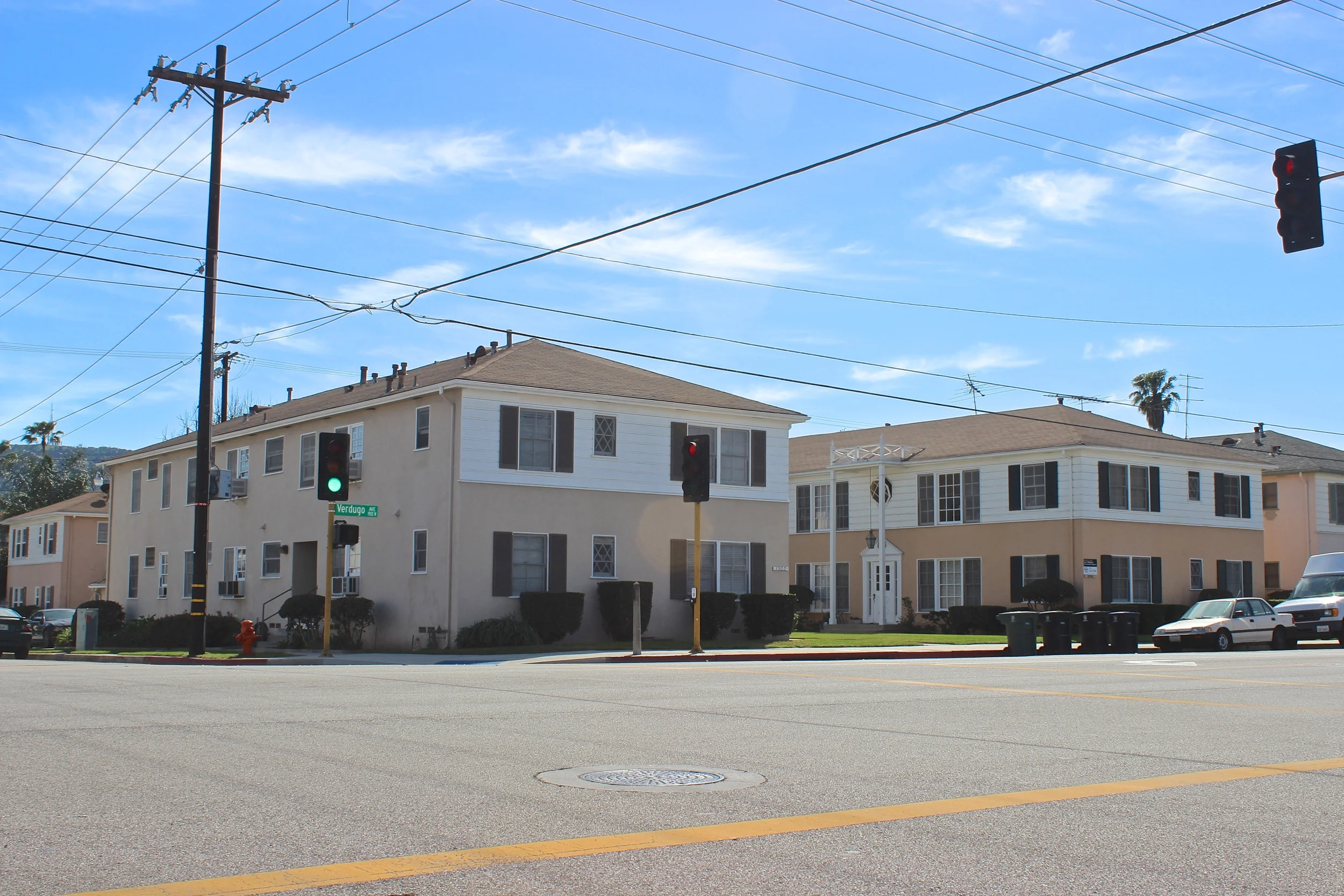 Street view brown and white complex with brown roof.