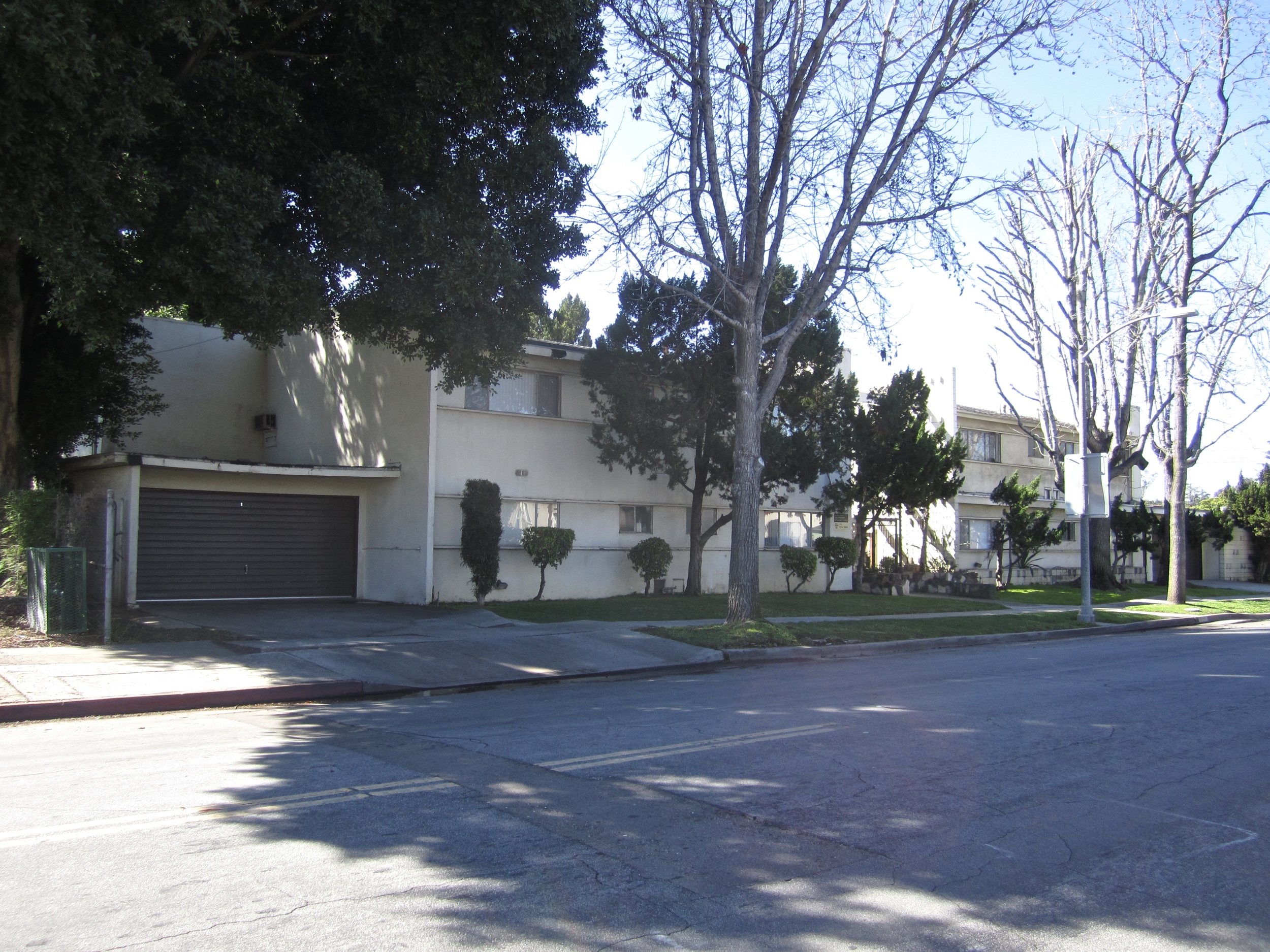White apartment building with gray garage door.