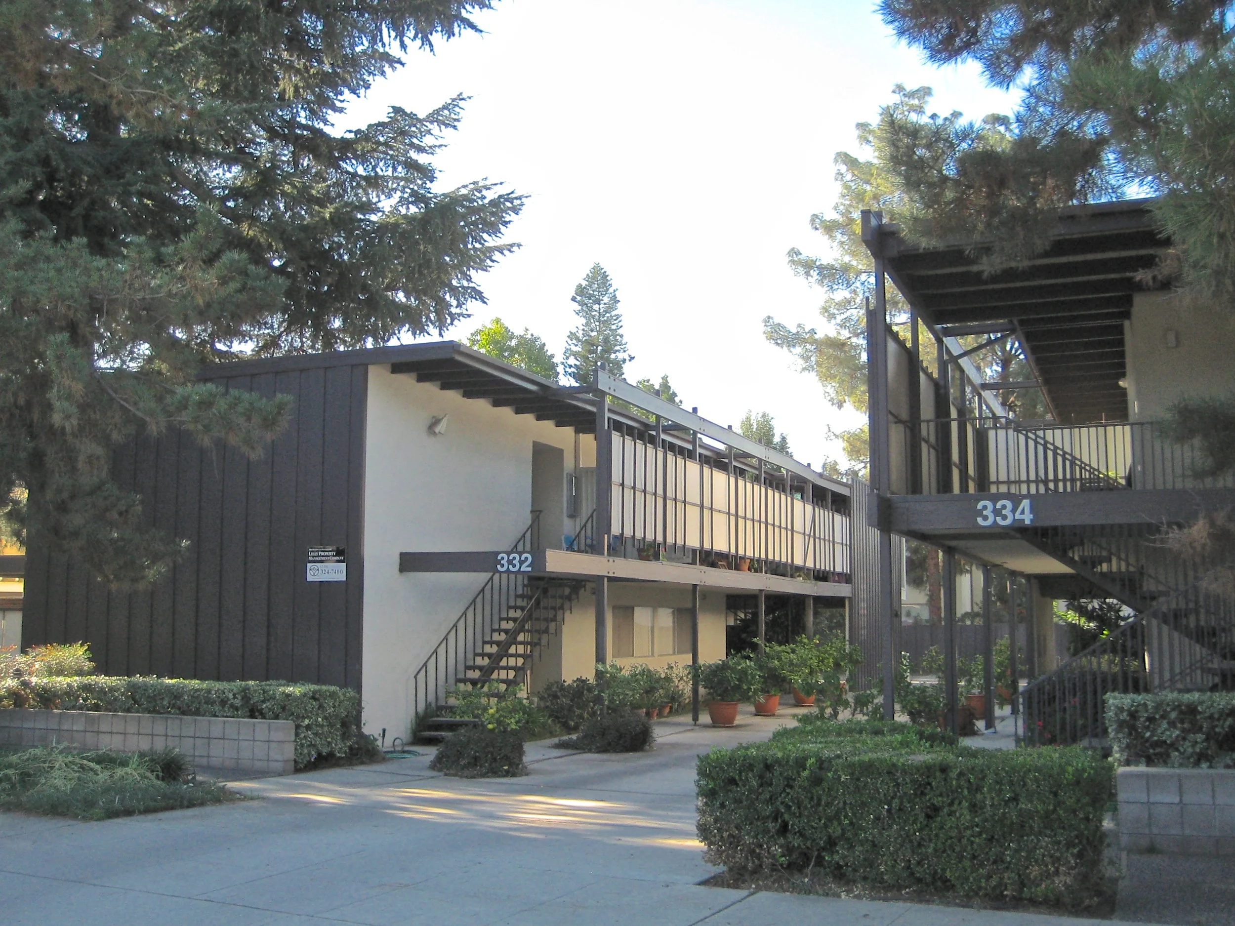 Two story apartment building with exterior stairs leading to the upper floor.