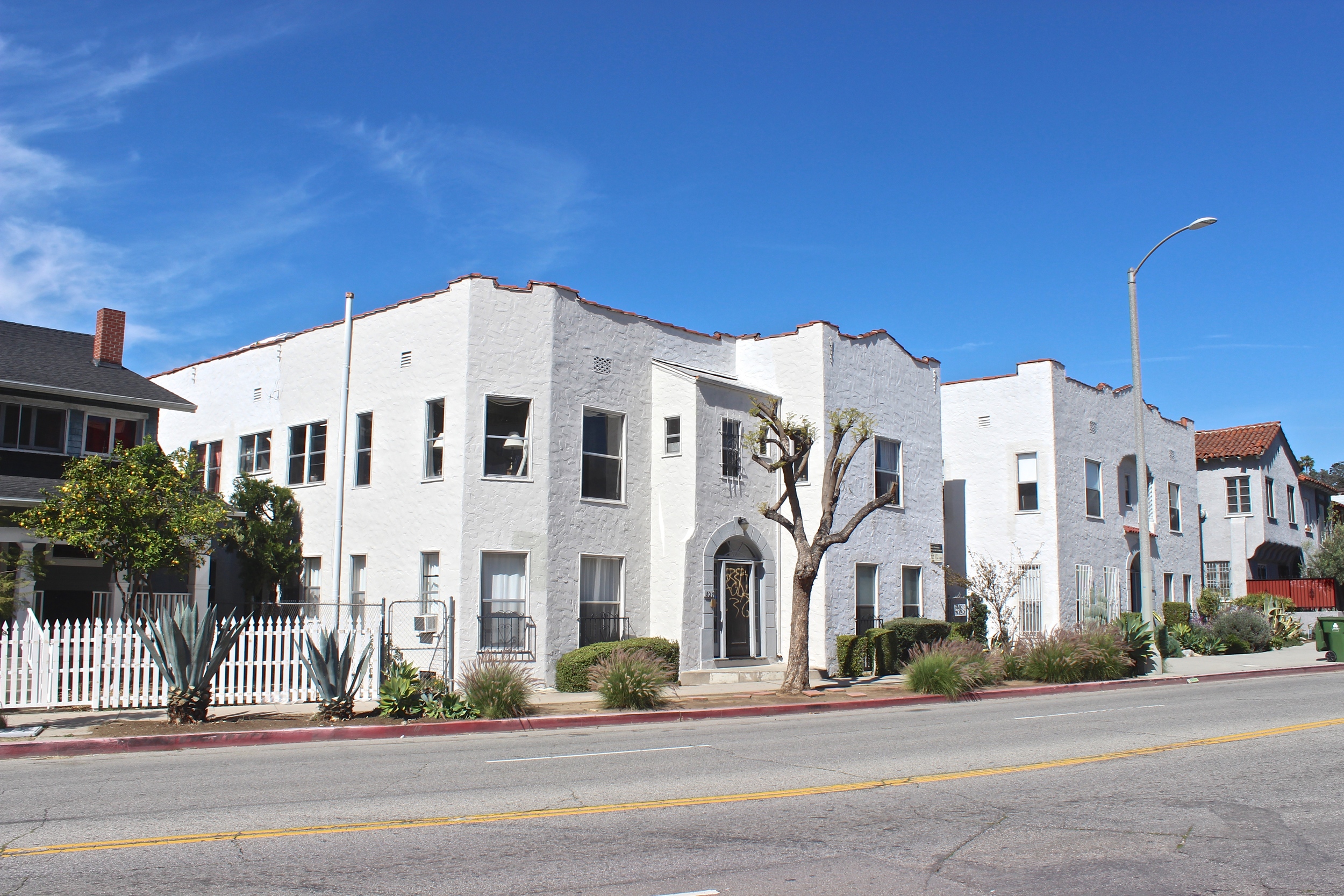  Street view of white two story apartment building.