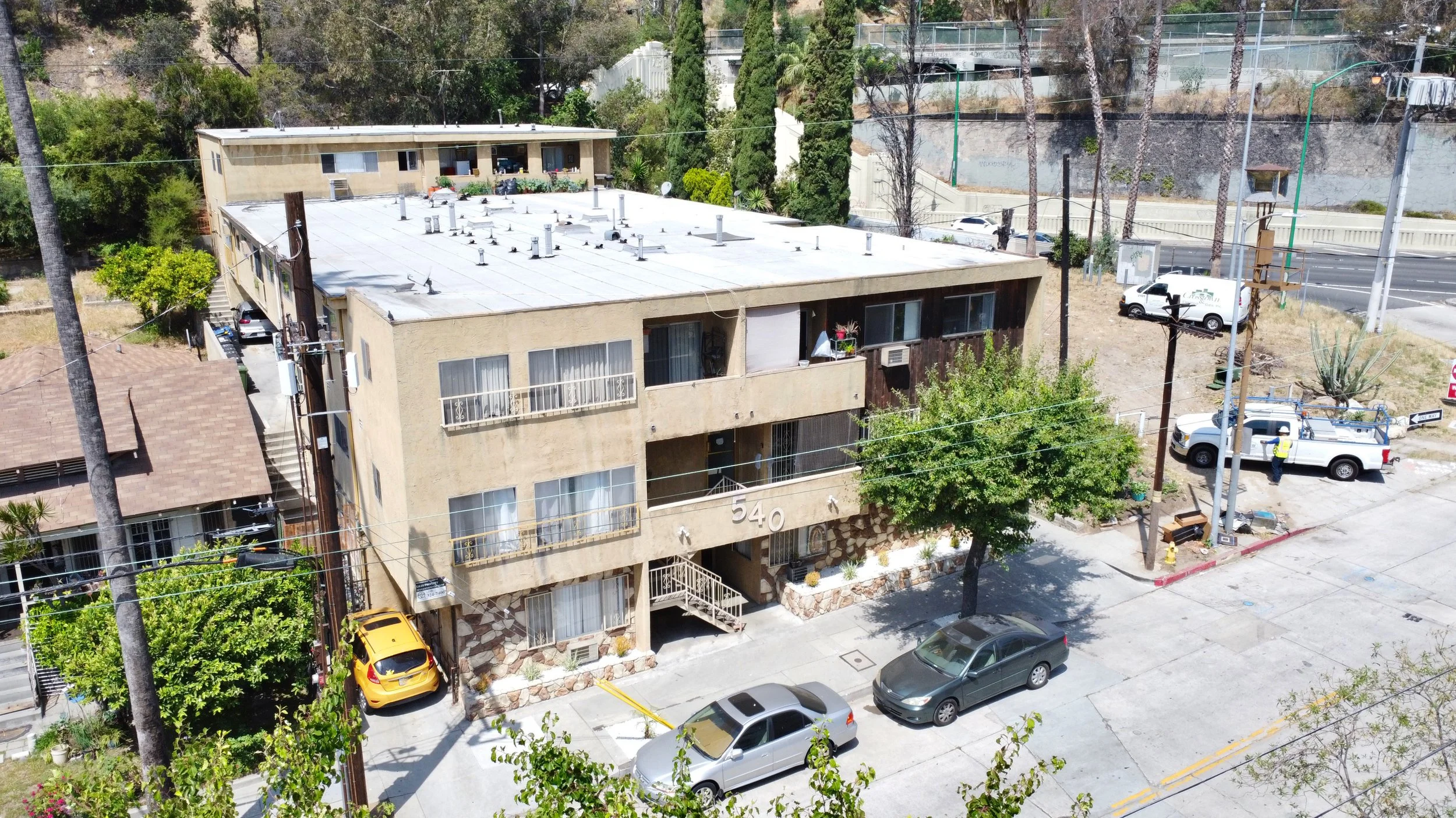 Tan three story apartment building.